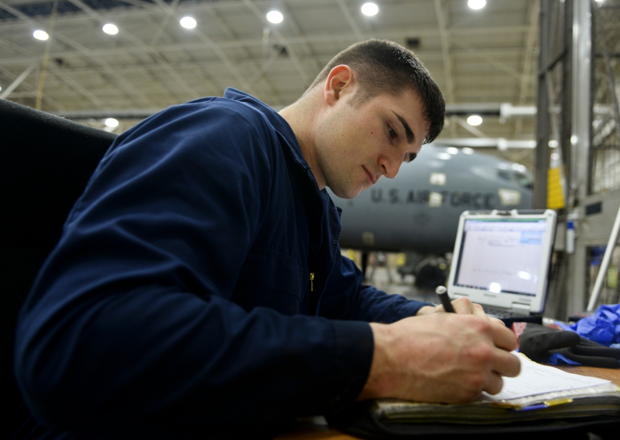 U.S. Air Force Senior Airman Ryan Whitney, 100th Aircraft Maintenance Squadron crew chief, logs which areas of a KC-135 Stratotanker have been cleaned Nov. 23, 2015, on RAF Mildenhall, England. From preparation to lubrication, aircraft washes are scheduled to last up to 72 hours. (U.S. Air Force photo by Staff Sgt. Micaiah Anthony/Released)