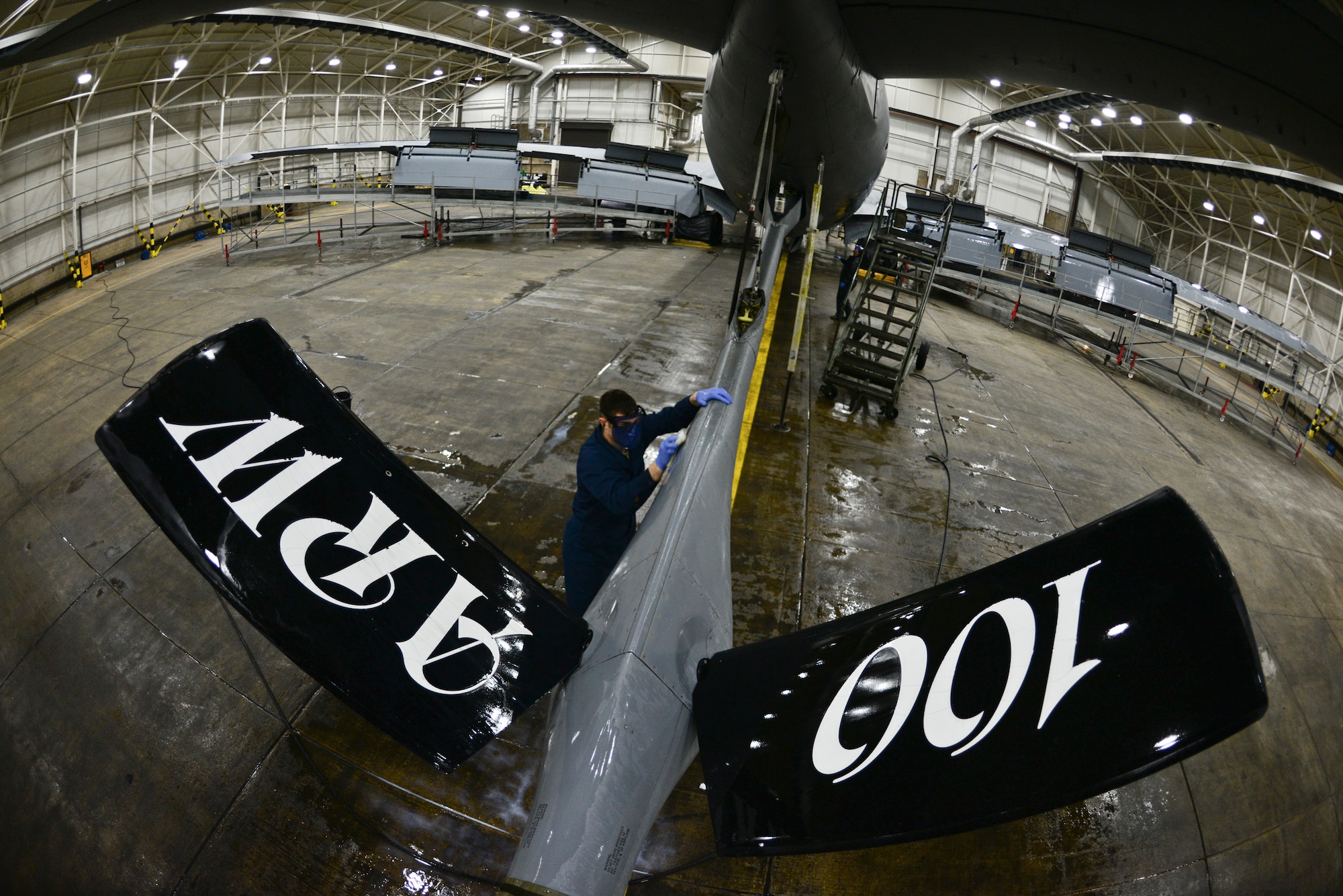 U.S. Air Force Senior Airman Ryan Whitney, 100th Aircraft Maintenance Squadron crew chief, cleans the boom pod of a KC-135 Stratotanker Nov. 23, 2015, on RAF Mildenhall, England. Whitney along with five other Airmen cleaned the 136-foot-long, 130-foot wing, 41-foot-tall aircraft to prevent corrosion, and reapplied fresh lubricant to prevent corrosion. (U.S. Air Force photo by Staff Sgt. Micaiah Anthony/Released)