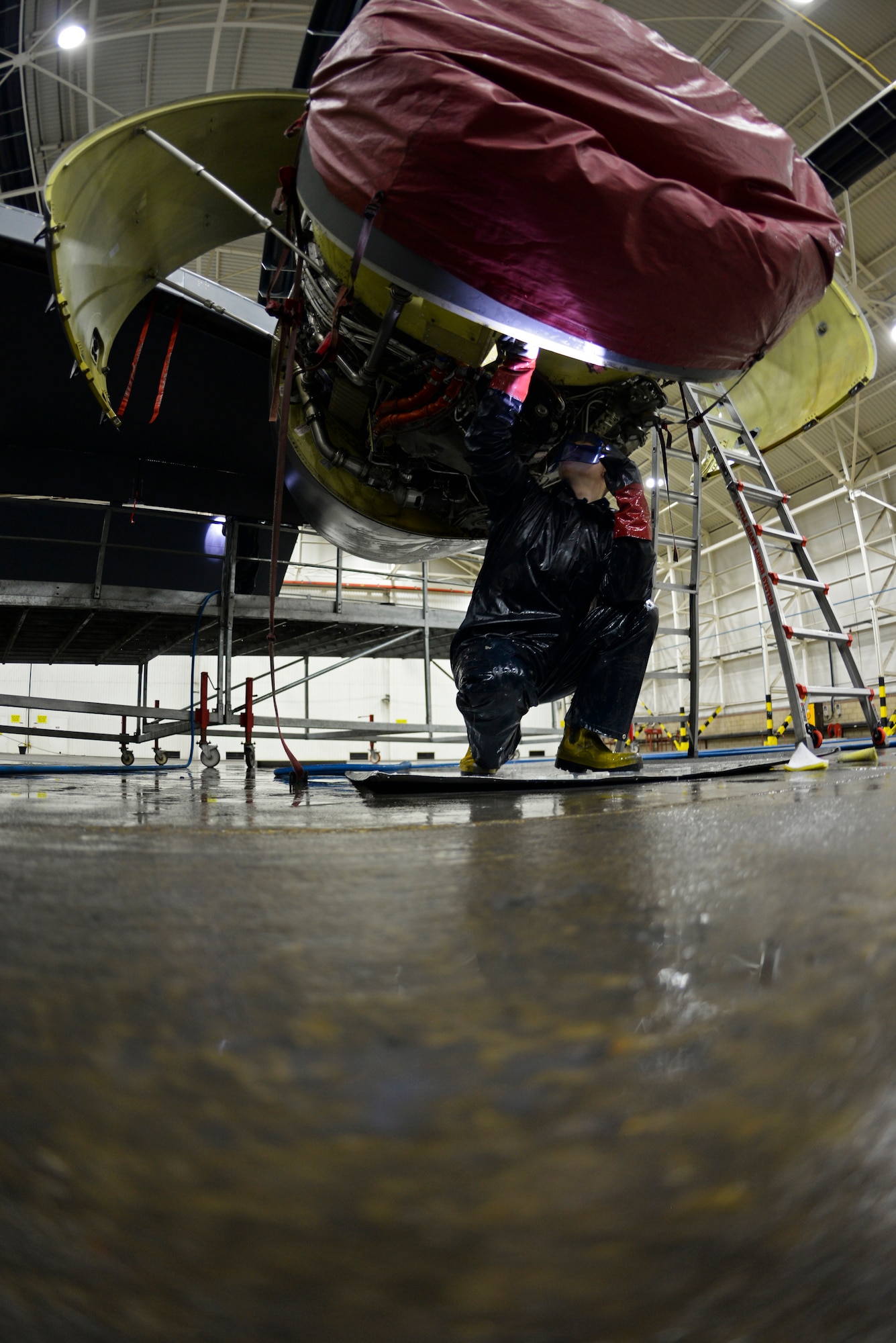 U.S. Air Force Airman 1st Class Jarrod Darnell, 100th Aircraft Maintenance Squadron crew chief, cleans an engine of a KC-135 Stratotanker Nov. 23, 2015, on RAF Mildenhall, England. To save time, the Airmen split up and started on the outer most regions of the aircraft and cleaned their way to the center. (U.S. Air Force photo by Staff Sgt. Micaiah Anthony/Released)