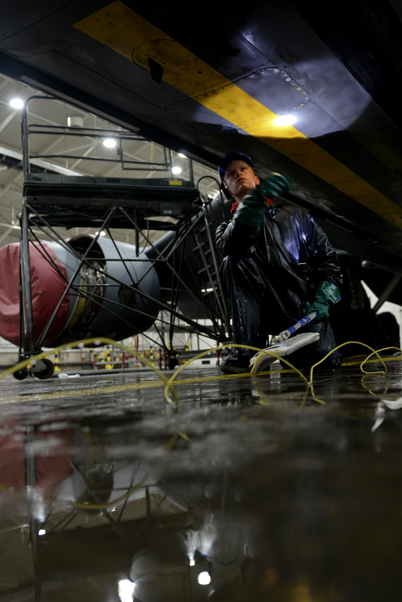 U.S. Air Force Airman Paul Hendra, 100th Maintenance Squadron aircraft structural maintenance apprentice, inspects the bottom of a KC-135 Stratotanker Nov. 23, 2015, on RAF Mildenhall, England. Airmen must ensure the aircraft is free of dirt, debris or grime that may be left over after they wash their designated areas. (U.S. Air Force photo by Staff Sgt. Micaiah Anthony/Released)
