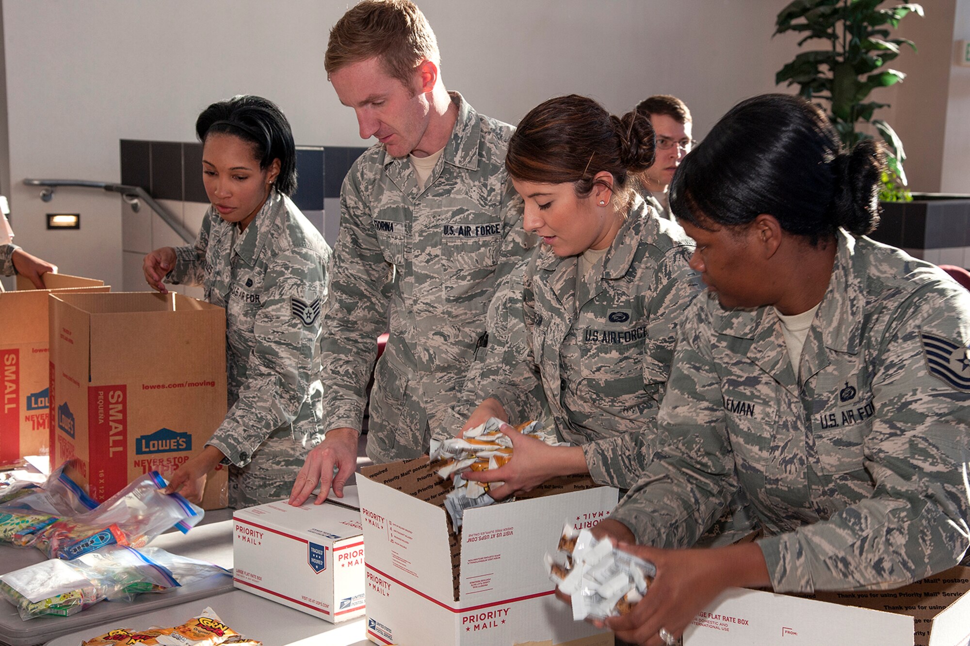 PETERSON AIR FORCE BASE, Colo. – Peterson Airmen put together holiday gift bags for 300 joint base and multinational personnel in support of the Operation Resolute Support Mission in Afghanistan. A collaborative effort between the Peterson 5/6 Council, Air Force Space Command Headquarters A2/3/6 Booster Club, and the Peterson AFB Company Grade Officer Council  packaged 300 individual bags Nov. 18, 2015 in a few hours, which filled 12 large boxes when they were complete. (U.S. Air Force photo by Craig Denton)