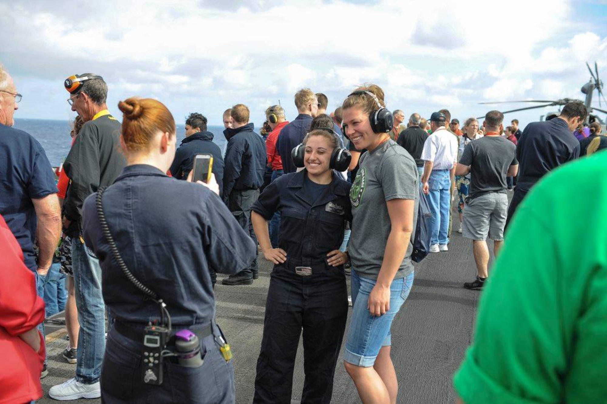 PACIFIC OCEAN – Senior Airman Rose Gudex poses for a photo with her co-sponsor, Electrician’s Mate Fireman Nicole LaBruzzo, before a gun power demonstration aboard the USS Theodore Roosevelt, Nov. 19, 2015. Gudex was on the Roosevelt for the 2015 Tiger Cruise where family and friends of Sailors and Marines were able to experience life aboard a ship for the final week of their deployment. Gudex was visiting her twin brother, Electrician’s Mate 3rd Class Ray Gudex. (U.S. Navy photo by Mass Communication Specialist 3rd Class Anthony N. Hilkowski)