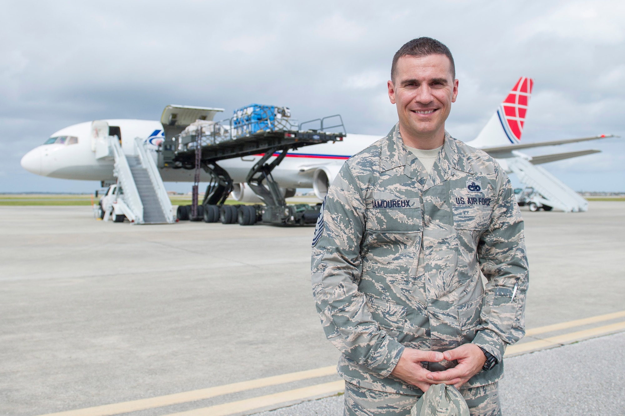 Chief Master Sgt. Jason Lamoureux, 45th Space Wing command chief, stopped in front of a pallet-loading B-757 commercial aircraft supporting the mission and personnel assigned to Ascension Island during a tour of the 45th Logistics Readiness Squadron Nov. 30, 2015, at Patrick Air Force Base, Fla. The chief met with 45th LRS personnel and was introduced to many facilities the 45th LRS uses in day-to-day operations. (U.S. Air Force photo by Matthew Jurgens/Released)