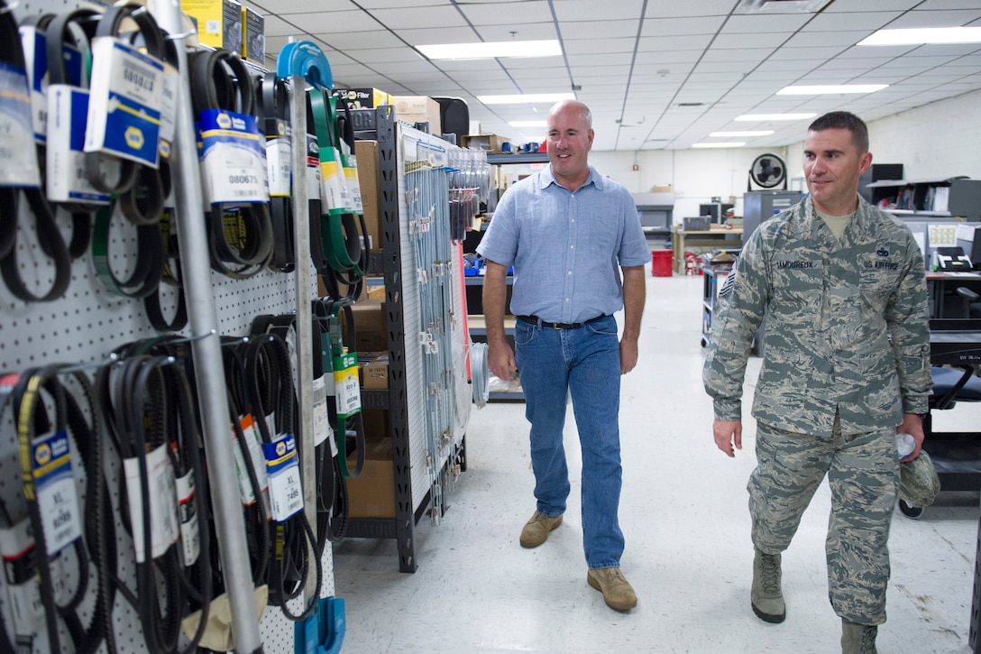 Dennis Julian, 45th Logistics Readiness Squadron Vehicle Management flight chief, escorts Chief Master Sgt. Jason Lamoureux, 45th Space Wing command chief, through the Materiel Control section Nov. 30, 2015, at Patrick Air Force Base, Fla. The chief met with 45th LRS personnel and was introduced to facilities the 45th LRS uses in day-to-day operations. (U.S. Air Force photo by Matthew Jurgens/Released)