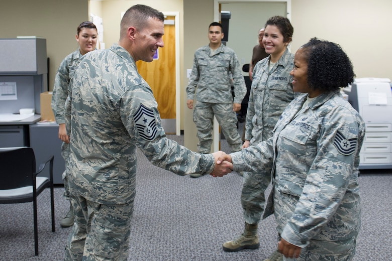 Chief Master Sgt. Jason Lamoureux, 45th Space Wing command chief, greets Tech. Sgt. Tawoina Rhine, Installation Personnel Readiness NCO, Nov. 30, 2015, at the 45th Logistics Readiness Squadron installation deployment readiness cell at Patrick Air Force Base, Fla. The chief met with 45th LRS personnel and was introduced to facilities the 45th LRS uses in day-to-day operations. (U.S. Air Force photo by Matthew Jurgens/Released)