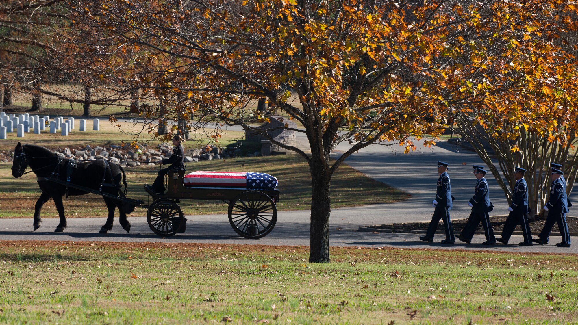 Members of the Little Rock Air Force Base Honor Guard march behind a caisson carrying retired U.S. Air Force Col. Michael Denington Nov. 19, 2015, at West Tennessee State Veteran's Cemetery. The honor guard performs at many military and civic ceremonies on base along with military funerals around the state of Arkansas. (U.S. Air Force photo by Senior Airman Scott Poe)