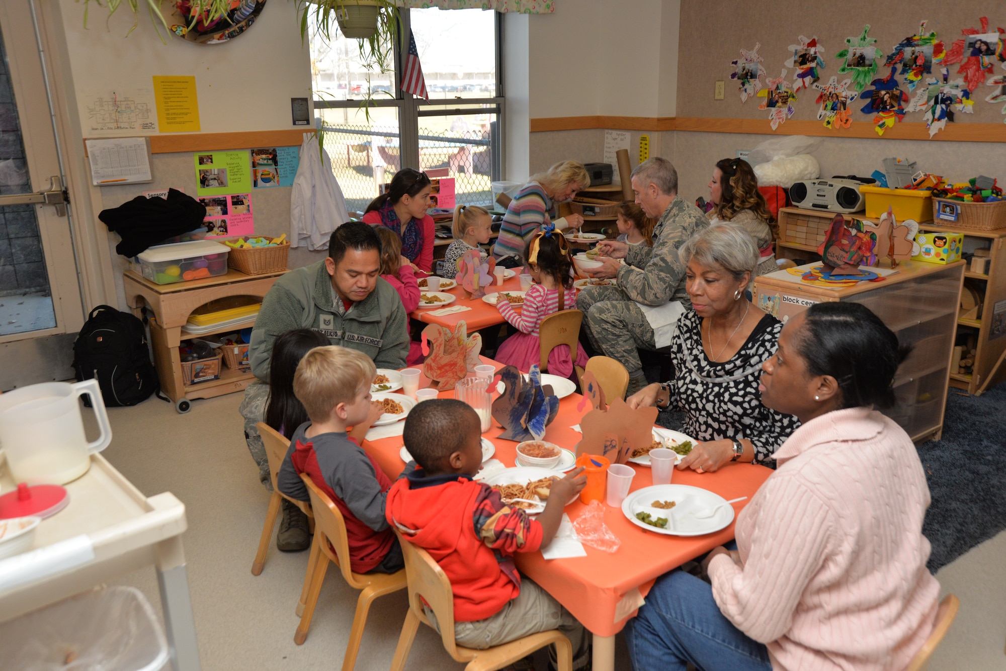 Families share a meal with their children during a Harvest Luncheon hosted by the Wright Care & New Horizon Child Development Center, Nov. 20, 2015, Wright-Patterson Air Force Base, Ohio. The CDC have many events ranging from fall festivals to summer bashes—the Harvest Luncheon was  an opportunity for parents to come and spend time with their child and enjoy a lunch in their child’s classroom. The children created decorations, such as paper turkeys for the event. (U.S. Air Force photo/Michelle Gigante)