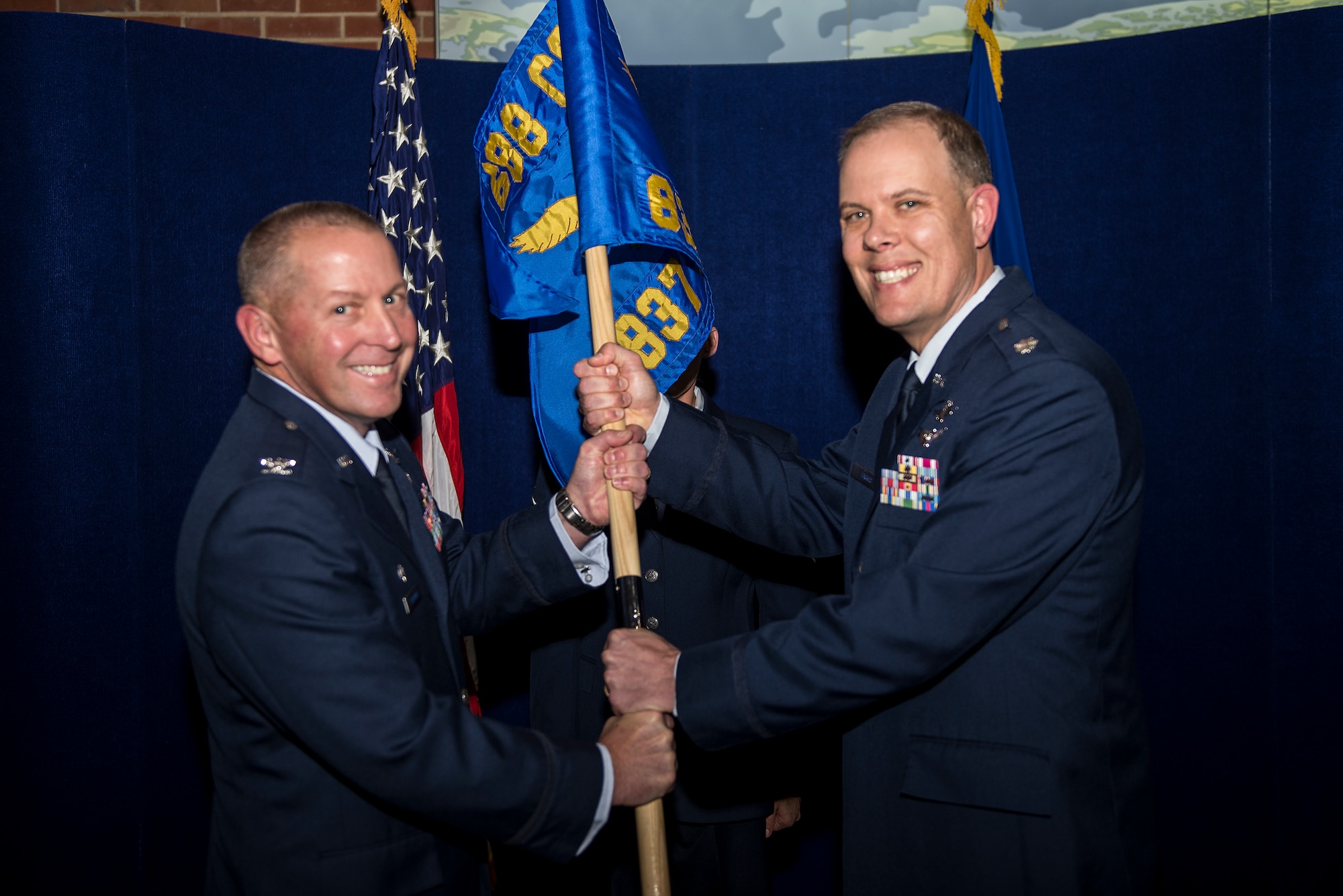 Col. Roger Vrooman, 688th Cyberspace Operations Group commander, passes the guidon to Lt. Col. Kevin Biggs during the 837th Cyberspace Operations Squadron activation ceremony Dec. 1 at Scott Air Force Base, Ill. Biggs will command the 837th responsible for defensive cyberspace operations supporting DOD and Combatant missions. (U.S. Air Force Photo/Senior Airman Jake Eckhardt)

