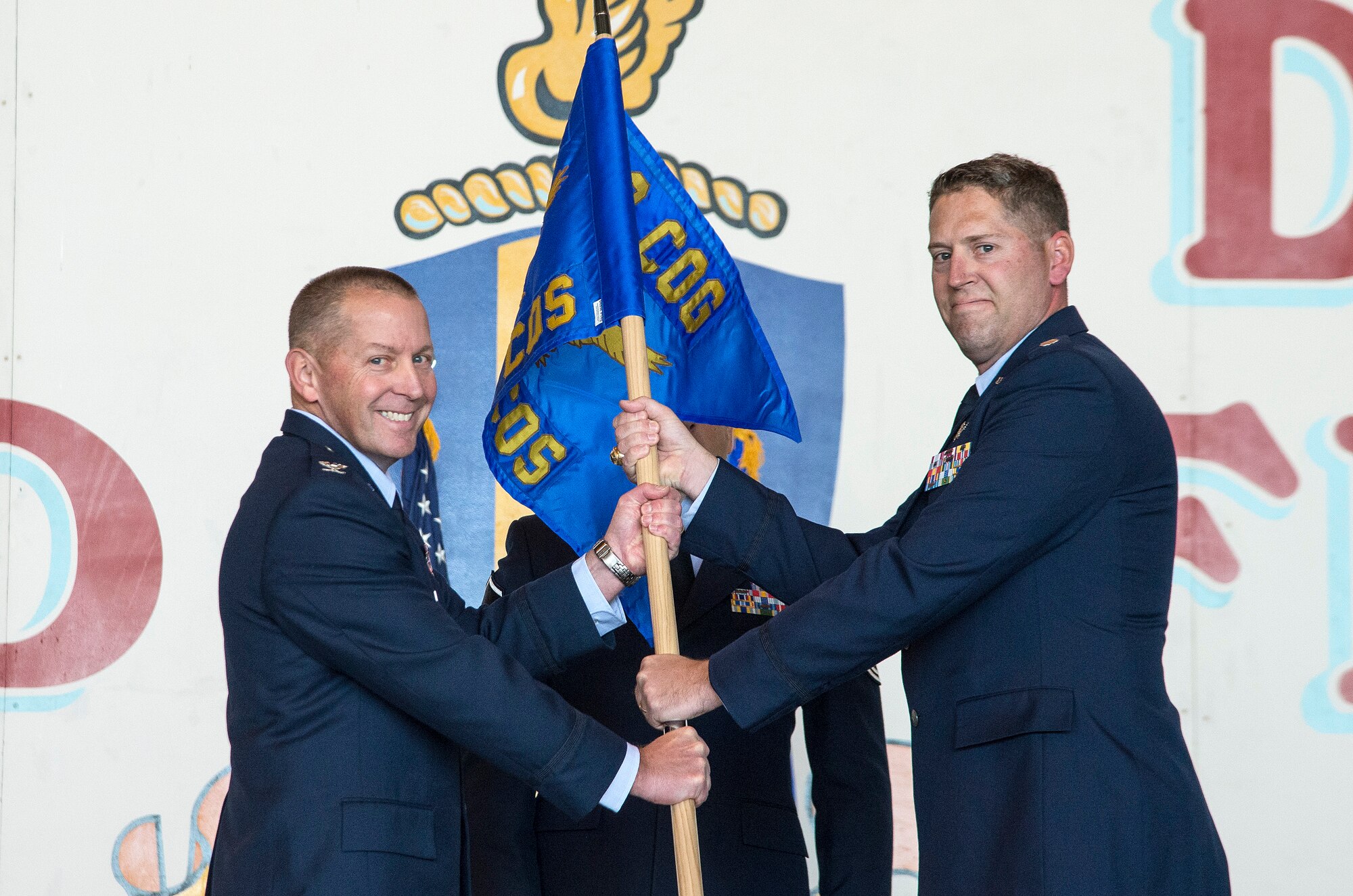Col. Roger R. Vrooman, 688th Cyberspace Operations Group commander, passes the guidon to Lt Col. Travis G. Howell as he assumes command of the 833rd Cyberspace Operations Squadron Dec. 3 at Joint Base San Antonio-Lackland. (U.S. Air Force photo by Johnny Saldivar)

