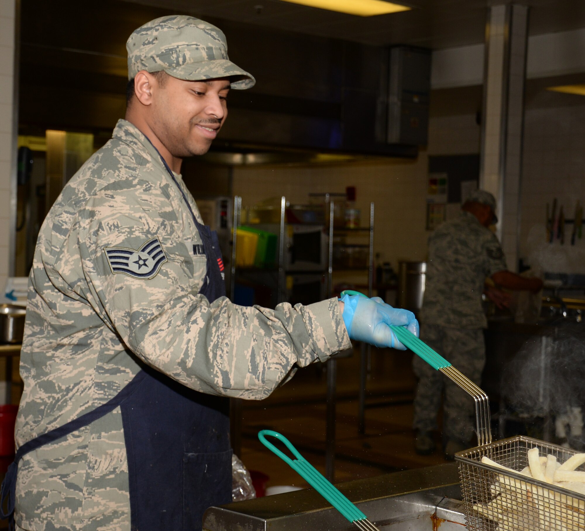 U.S. Air Force Staff Sgt. Christopher Williams, 100th Force Support Squadron Gateway Dining Facility shift supervisor, prepares food to be served during lunch Nov. 23, 2015, on RAF Mildenhall, England. Williams has recently moved from the 100th FSS Readiness section as he prepares to move to his new base in January. Williams has been stationed at RAF Mildenhall since January 2012. (U.S. Air Force photo by Gina Randall/Released)