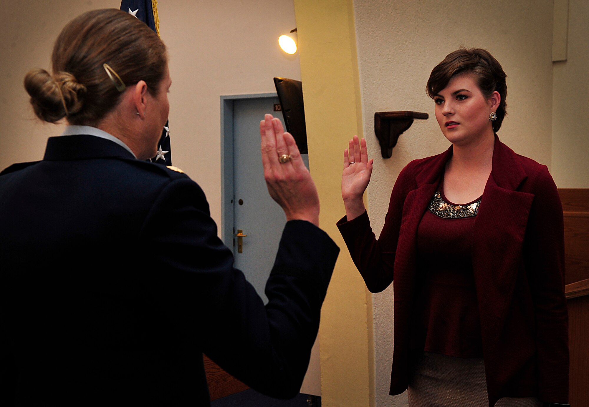 Maj. Brittany Nutt, 86th Medical Squadron women's health nurse practitioner, swears her daughter, Kiersten, into the Air Force before she leaves for basic military training Nov. 23, 2015, at Landstuhl Regional Medical Center, Germany. Both of Kiersten’s parents enlisted in the Air Force, and her mother commissioned after her first four-year enlistment. (U.S. Air Force photo/Airman 1st Class Larissa Greatwood) 