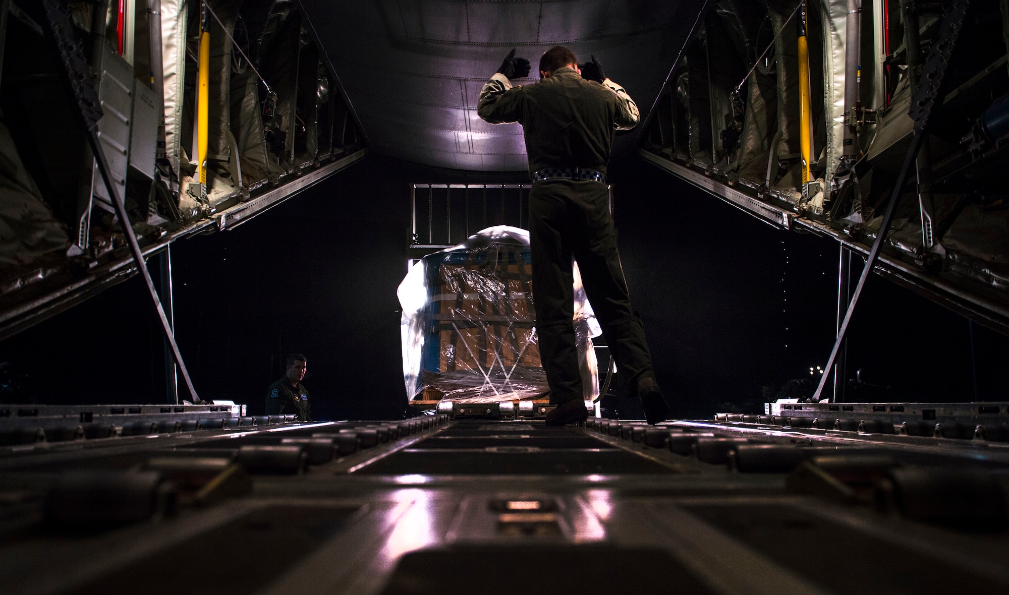 Loadmasters from the 37th Airlift Squadron prepare a C-130J Super Hercules for flight Nov. 25, 2015, at Ramstein Air Base, Germany. Aircrew members flew to U.S. Army Garrison Grafenwoehr, Germany, for airdrop training. (U.S. Air Force photo/Staff Sgt. Sara Keller)