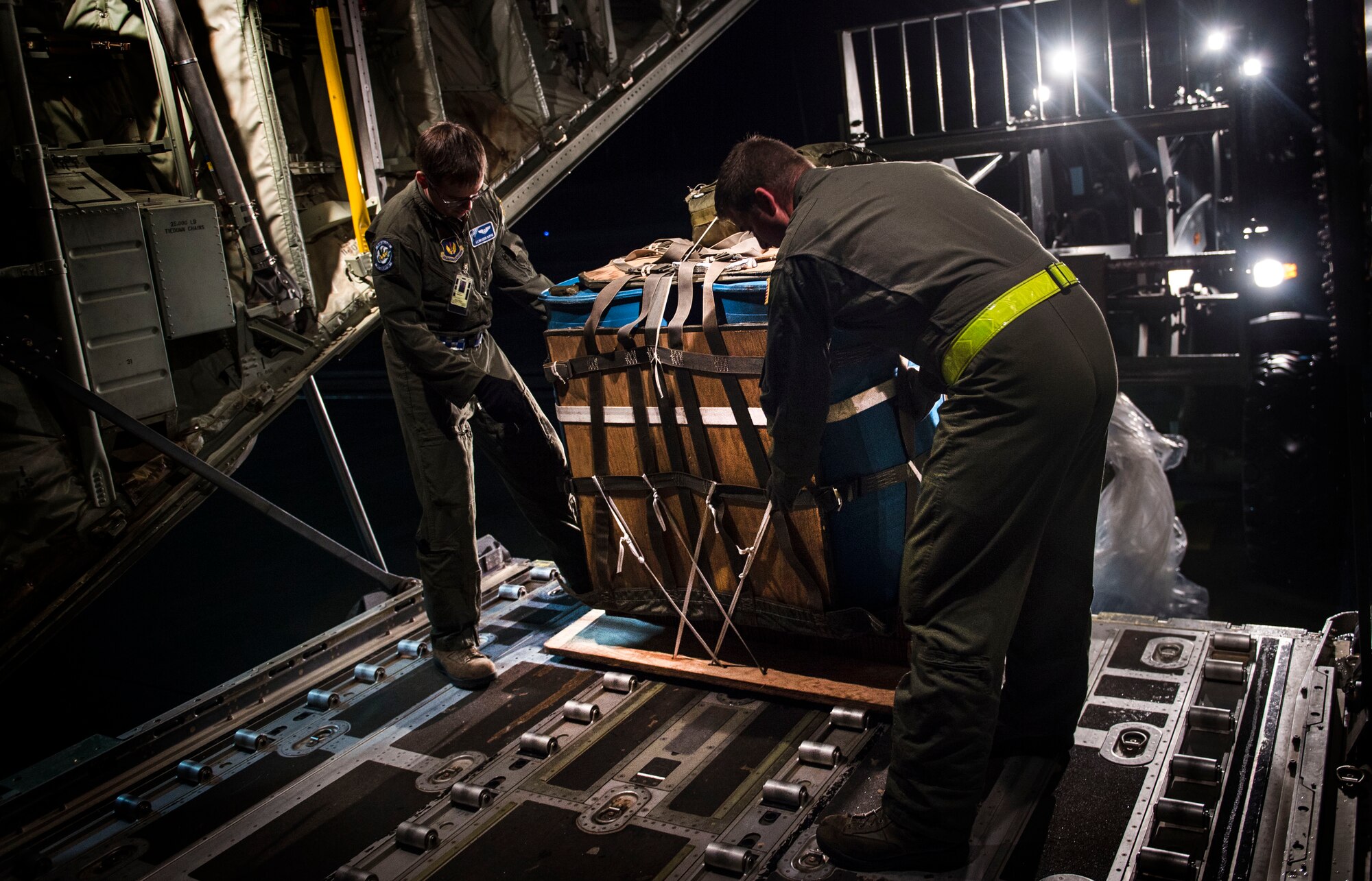 Loadmasters from the 37th Airlift Squadron load water onto a C-130J Super Hercules Nov. 25, 2015, at Ramstein Air Base, Germany. The water was used to simulate supplies being airdropped during a training mission over Grafenwoehr, Germany . (U.S. Air Force photo/Staff Sgt. Sara Keller)