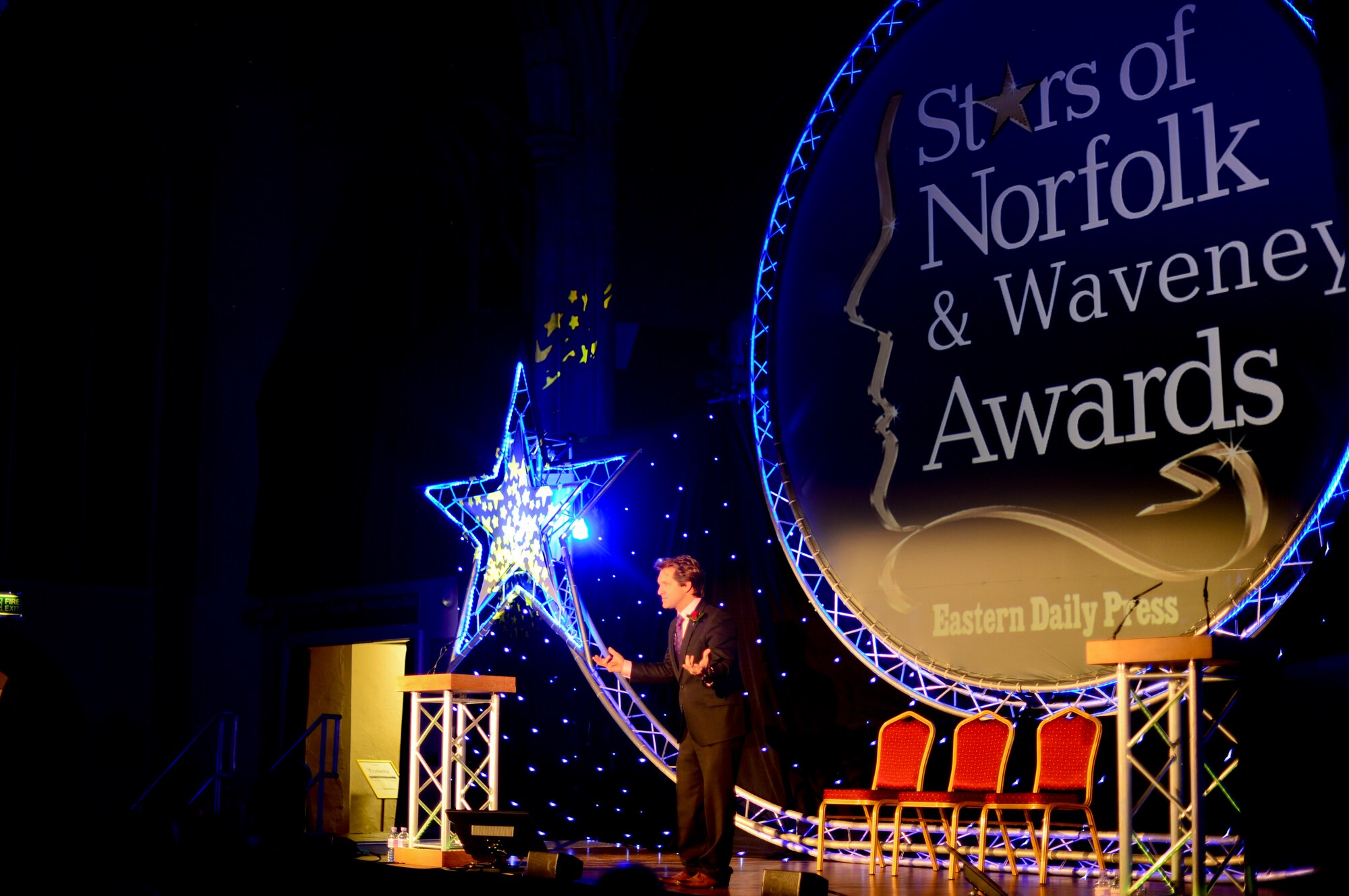 David Whiteley, BBC Radio and Stars of Norfolk and Waveney Awards host, provides opening remarks during the ceremony at St. Andrews Halls, Norfolk, England, Dec. 3, 2015. Staff Sgt. Eli Gordon, 492nd Aircraft Maintenance Unit activity security manager, was named the winner for the Armed Services Person of the Year award. (U.S. Air Force photo by Senior Airman Erin Trower)