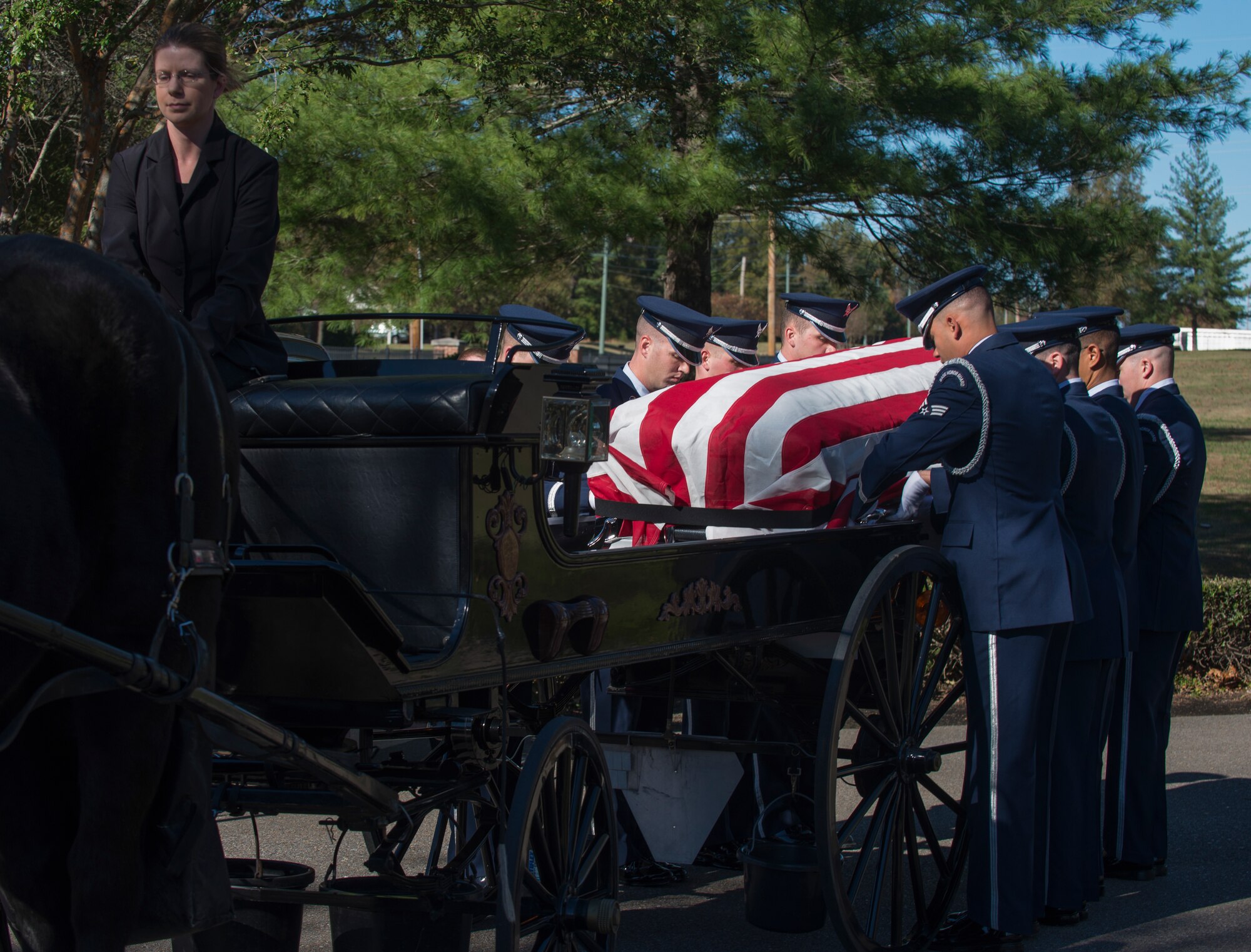Members of the Little Rock Air Force Base Honor Guard place a casket carrying retired U.S. Air Force Col. Michael Denington onto a caisson Nov. 19, 2015, at West Tennessee State Veteran's Cemetery. The base Honor Guard performed more than a thousand details last year. (U.S. Air Force photo by Senior Airman Scott Poe)