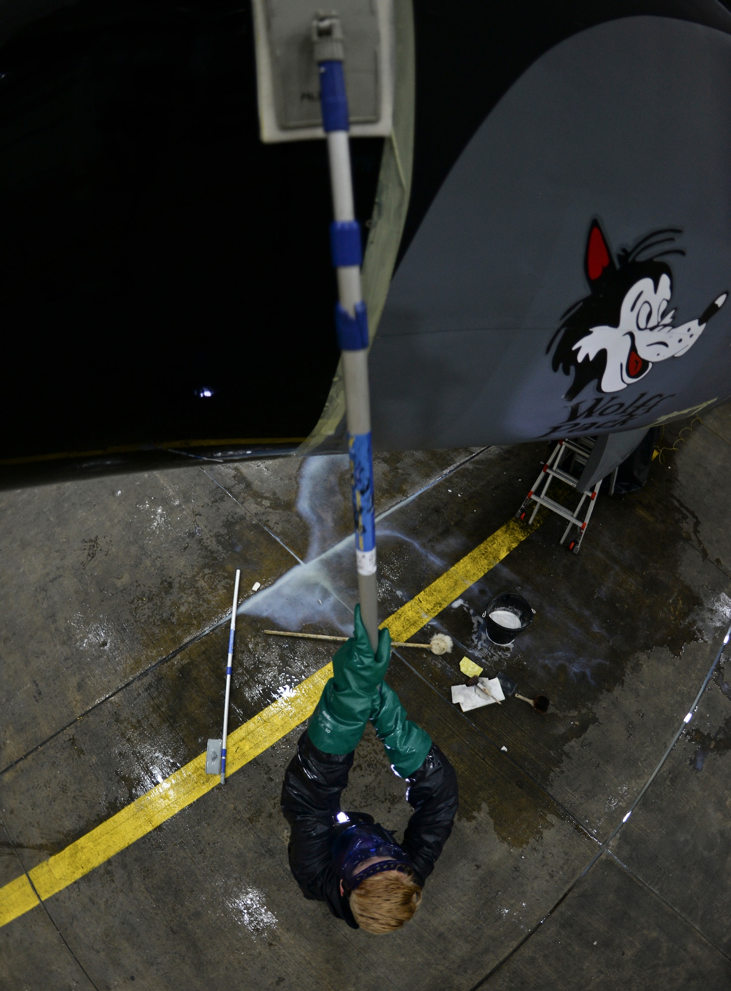 U.S. Air Force Airman Paul Hendra, 100th Maintenance Squadron aircraft structural maintenance apprentice, scrubs the side of a KC-135 Stratotanker Nov. 23, 2015, on RAF Mildenhall, England. To save time, the Airmen split up and started on the outer most regions of the aircraft and cleaned their way to the center. (U.S. Air Force photo by Staff Sgt. Micaiah Anthony/Released)