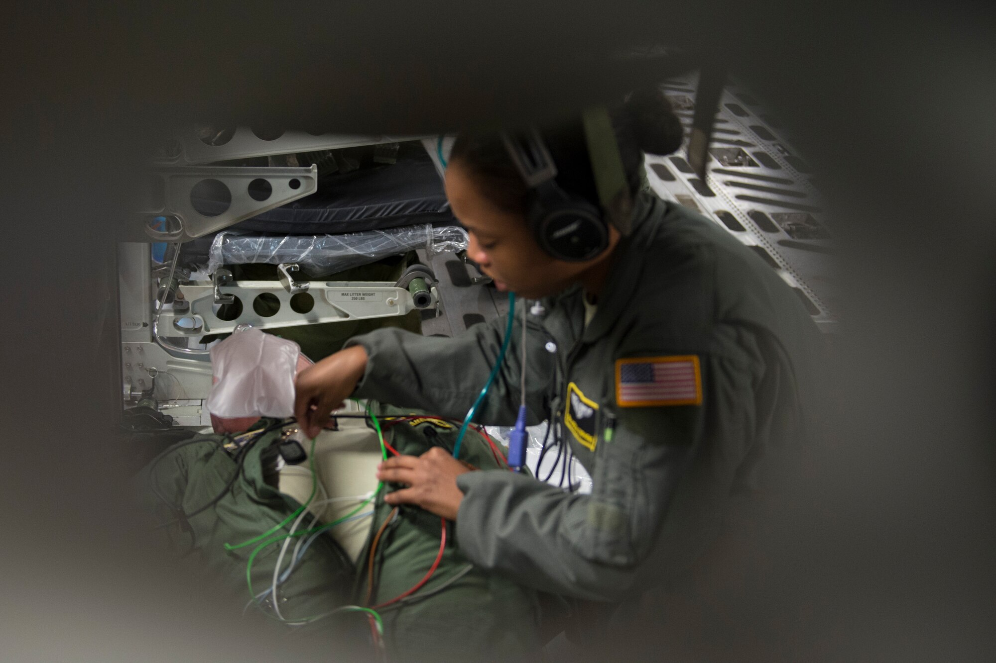 An aeromedical evacuation expert, Scott Air Force Base, Illinois, practices on a patient during a collaborative Air Mobility Command training initiative Nov. 16–20. Multiple challenging scenarios were presented to the crews to include patient problems both with mannequins and co-workers acting as patients. (U.S. Air Force photo by Airman 1st Class Melissa Estevez)