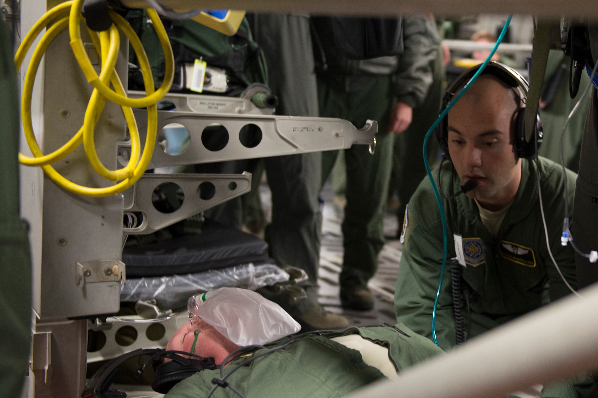 An aeromedical evacuation expert, Scott Air Force Base, Illinois, practices on a patient during a collaborative Air Mobility Command training initiative Nov. 16–20. Multiple challenging scenarios were presented to the crews to include patient problems both with mannequins and co-workers acting as patients. (U.S. Air Force photo by Airman 1st Class Melissa Estevez)