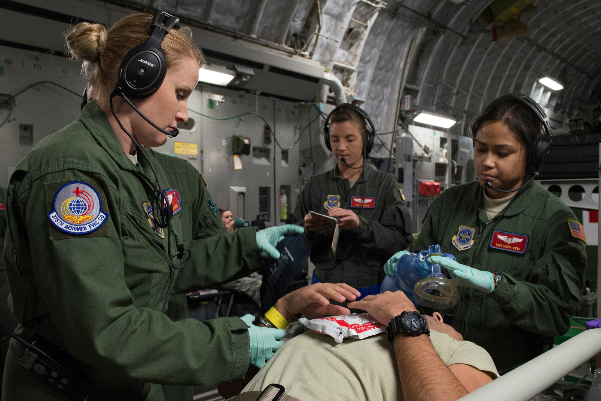 An aeromedical evacuation expert, Scott Air Force Base, Illinois, practices on a patient during a collaborative Air Mobility Command training initiative Nov. 16–20. Multiple challenging scenarios were presented to the crews to include patient problems both with mannequins and co-workers acting as patients. (U.S. Air Force photo by Airman 1st Class Melissa Estevez)