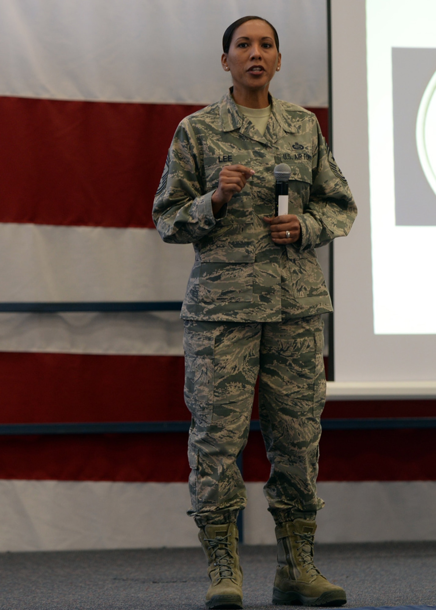 Chief Master Sgt. Sonia Lee, 28th Bomb Wing command chief, addresses Airmen at an all call at the Pride Hangar at Ellsworth Air Force Base, S.D., Dec. 3, 2015. Lee discussed the importance of the Air Force core values and how upholding them can assist with accepting change and finding solutions to issues the wing and Air Force is facing. (U.S. Air Force photo by Airman Donald C. Knechtel/Released)