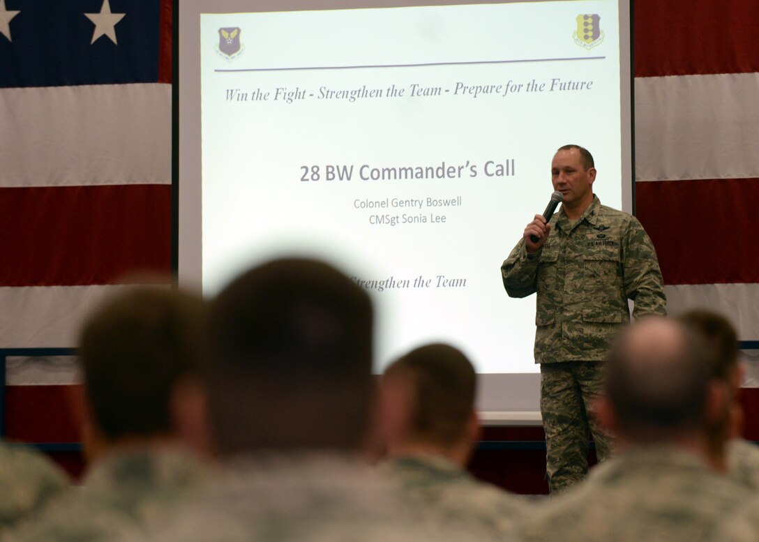 Col. Gentry Boswell, 28th Bomb Wing commander, addresses Airmen at an all call at the Pride Hangar at Ellsworth Air Force Base, S.D., Dec. 3, 2015. Boswell touched on winter safety, wing accomplishments, future operations and his thoughts for the next year. (U.S. Air Force photo by Airman Donald C. Knechtel/Released)