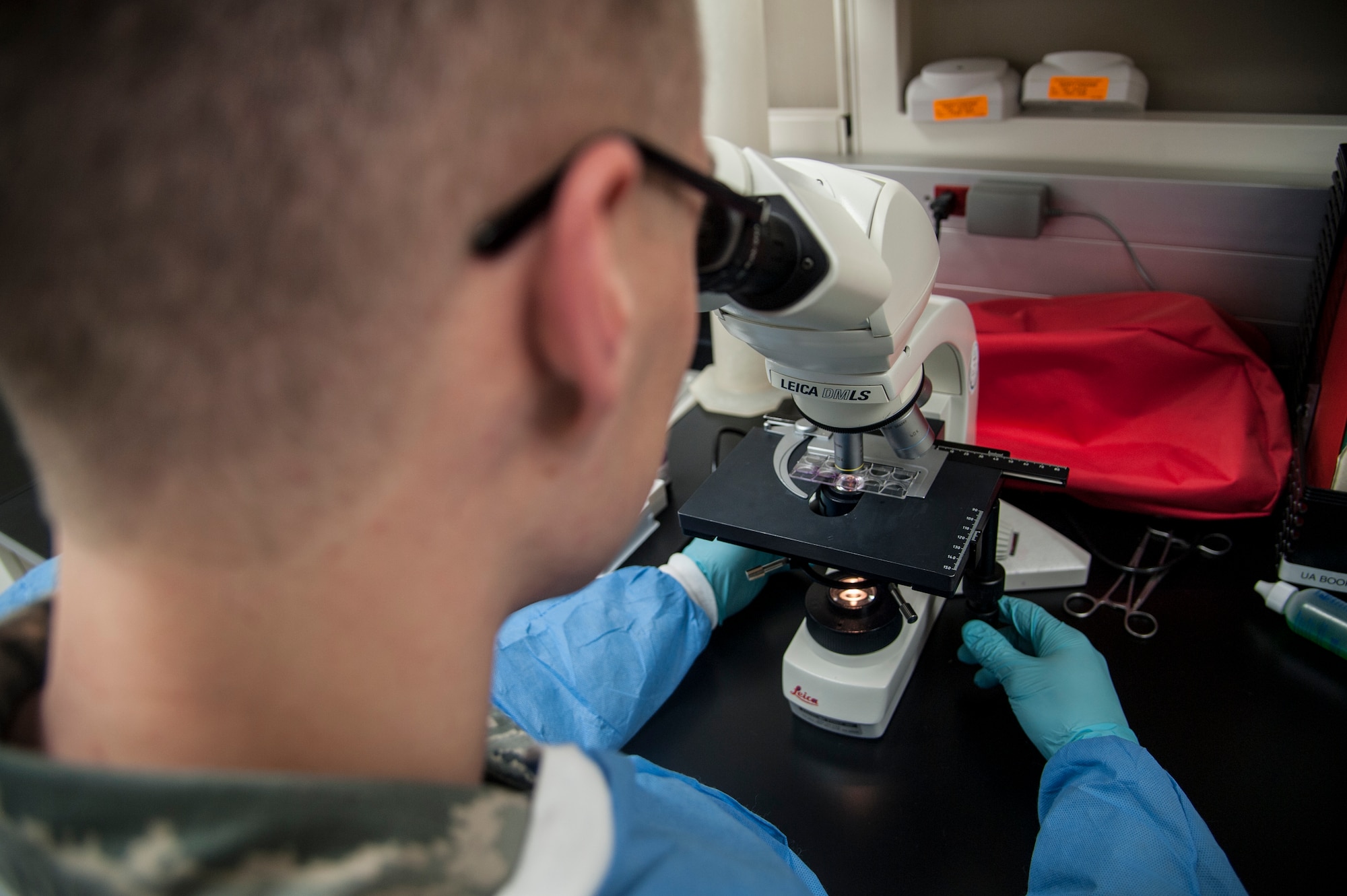 Senior Airman David Gehring, 92nd Medical Support Squadron medical laboratory technician, examines a blood slide Dec. 1, 2015, Fairchild Air Force Base, Wash. The average turnaround time for test results is less than two hours with the majority of tests taking between 30 minutes to an hour. (U.S. Air Force photo/Airman 1st Class Sean Campbell)