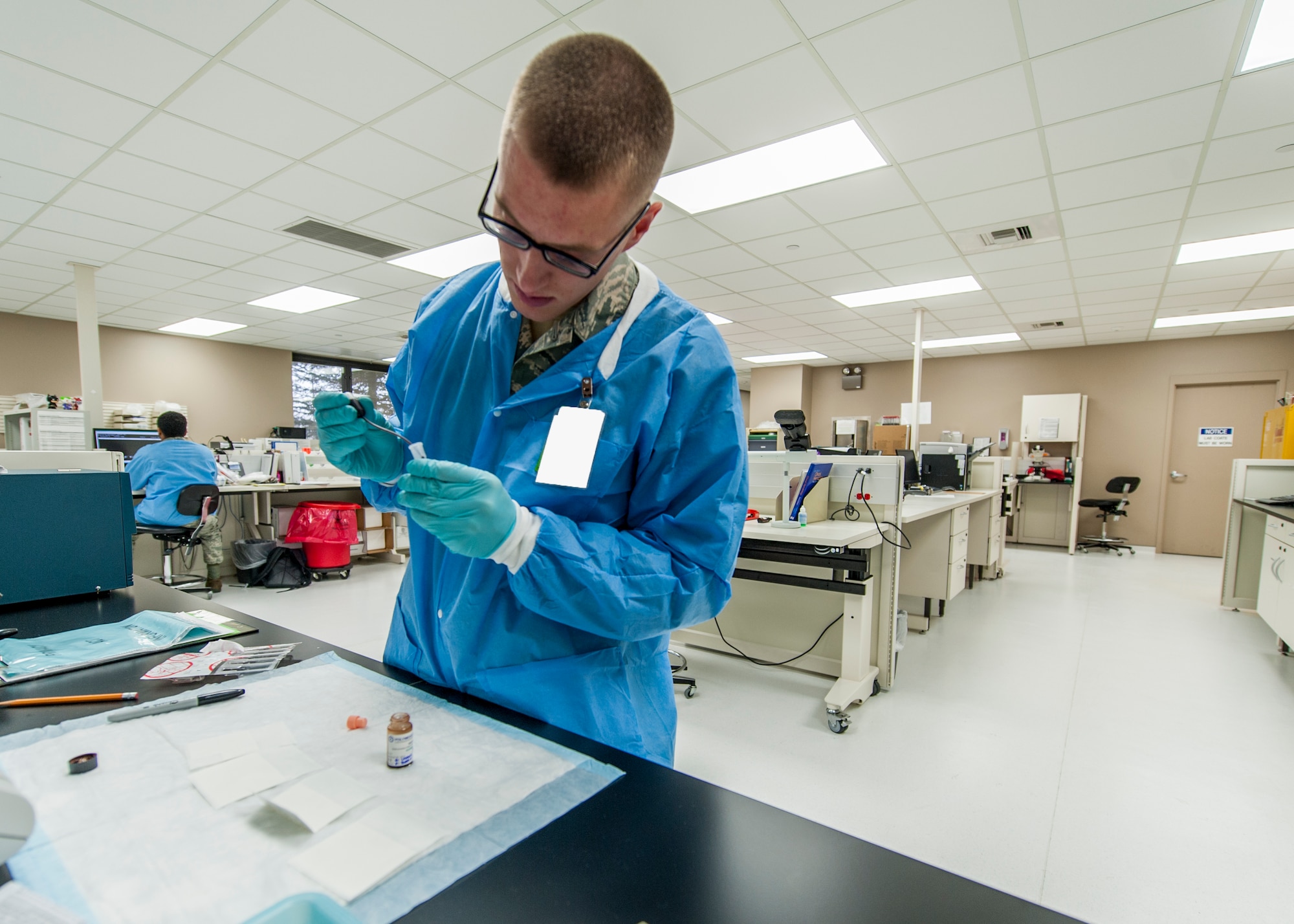 Senior Airman David Gehring, 92nd Medical Support Squadron medical laboratory technician, conducts lab work Dec. 1, 2015, Fairchild Air Force Base, Wash. The average turnaround time for test results is less than two hours with the majority of tests taking between 30 minutes to an hour. (U.S. Air Force illustration/Airman 1st Class Sean Campbell)