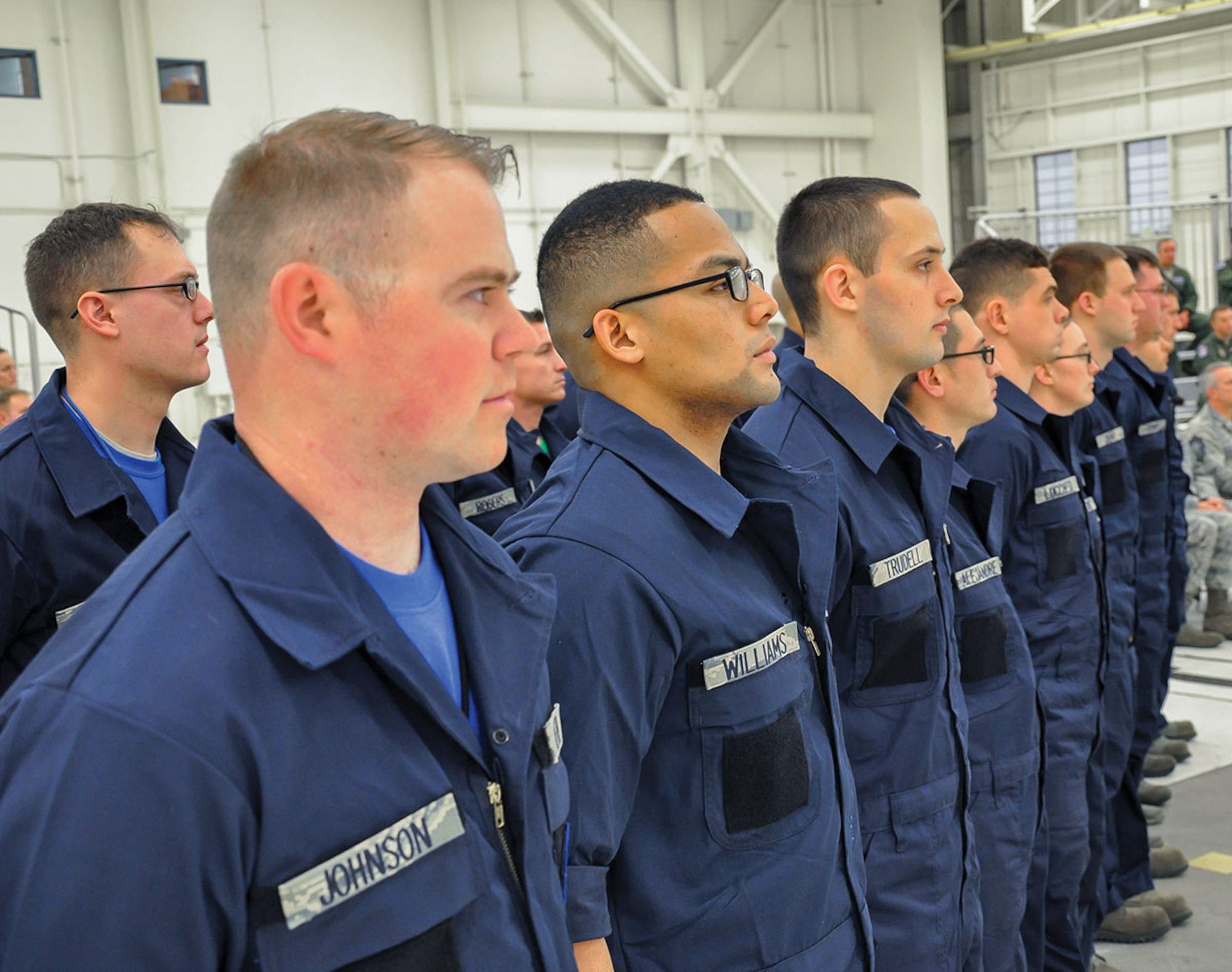 Dedicated crew chiefs from the 525th Fighter Squadron stand to recite the crew chief creed during a DCC ceremony Nov. 25. The ceremony recognized the top F-22 maintainers on the installation, honors for which include wearing specialized coveralls and his name printed on the side of a jet. (U.S. Air Force photo/Staff Sgt. Wes Wright)