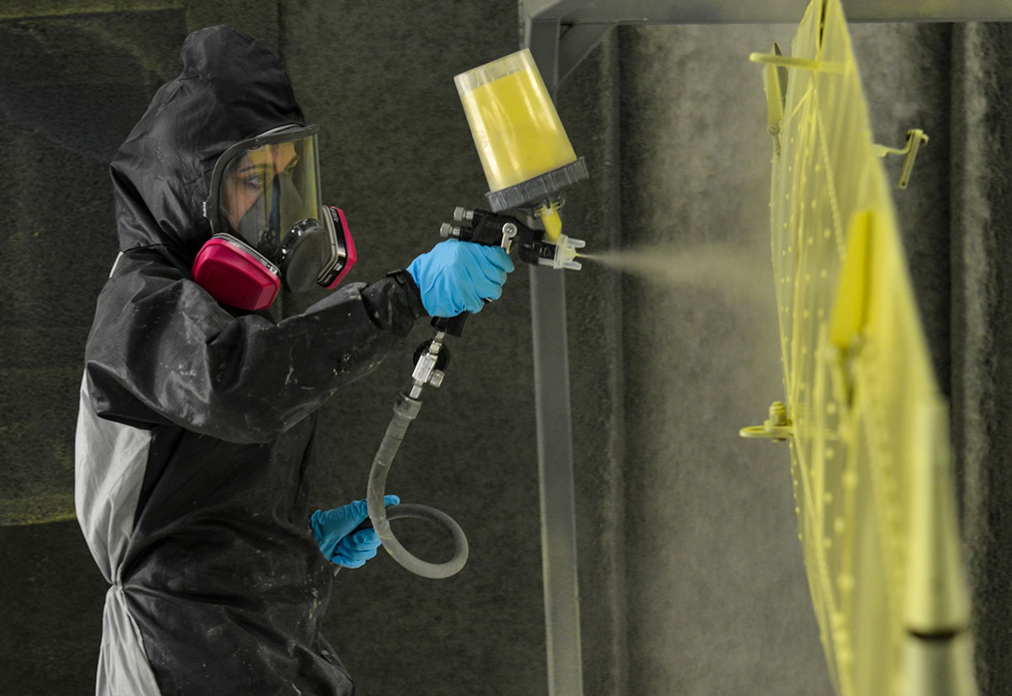 Airman Melissa Weaver, 3rd Maintenance Squadron, Aircraft Structural Maintenance Flight apprentice paints the wing of a KD2R5 “Shelduck” basic training drone in a Hangar 21 paint room Nov. 24. Drones like this one were used as target practice for pilots in the mid-20th century. This drone, once refurbished, will hang in the Alaska Veteran’s Museum in Anchorage.  (U.S. Air Force photo/ Airman 1st Class Kyle Johnson)