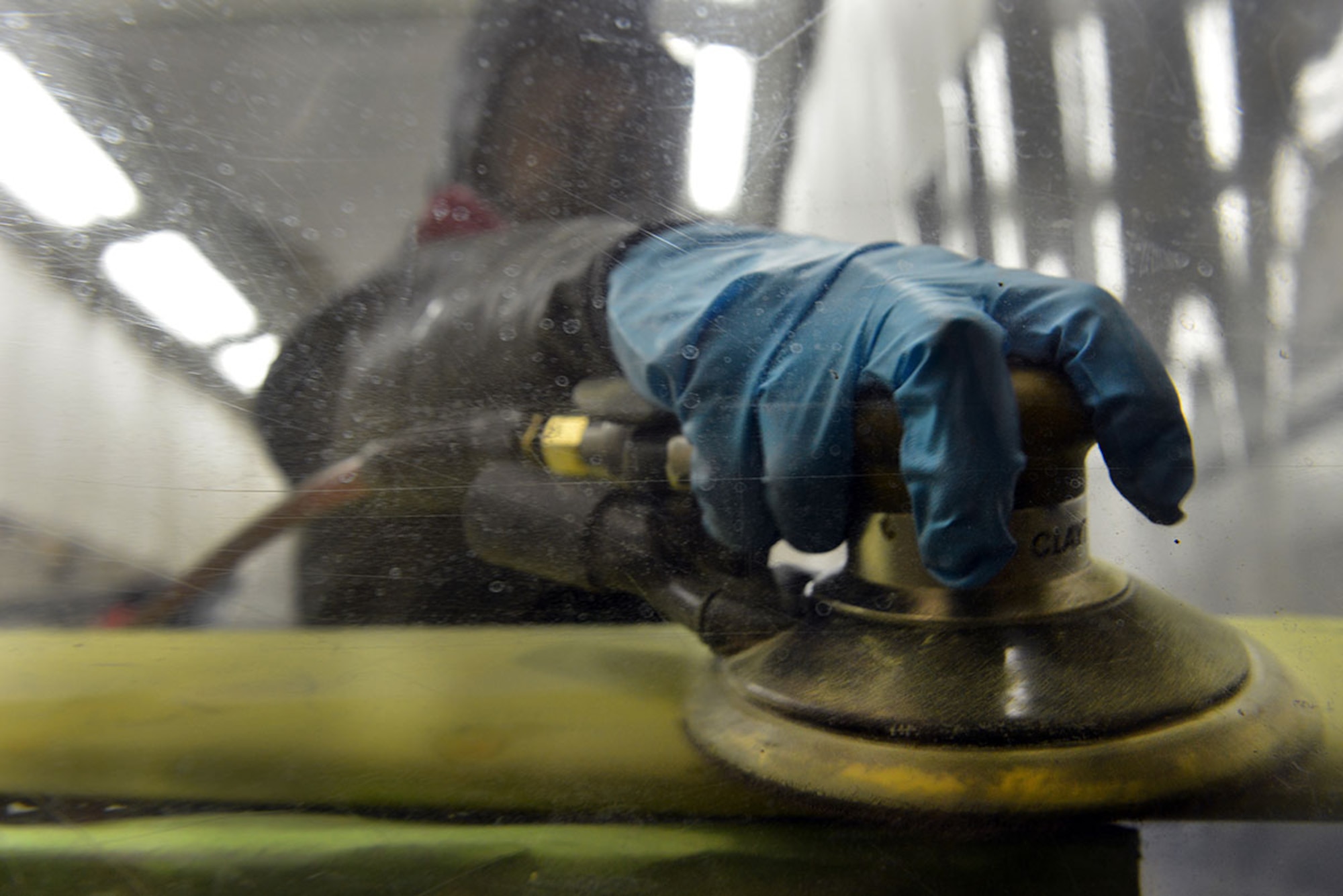 Weaver sands the wing of the Shelduck between coats of paint.  (U.S. Air Force photo/ Airman 1st Class Kyle Johnson)