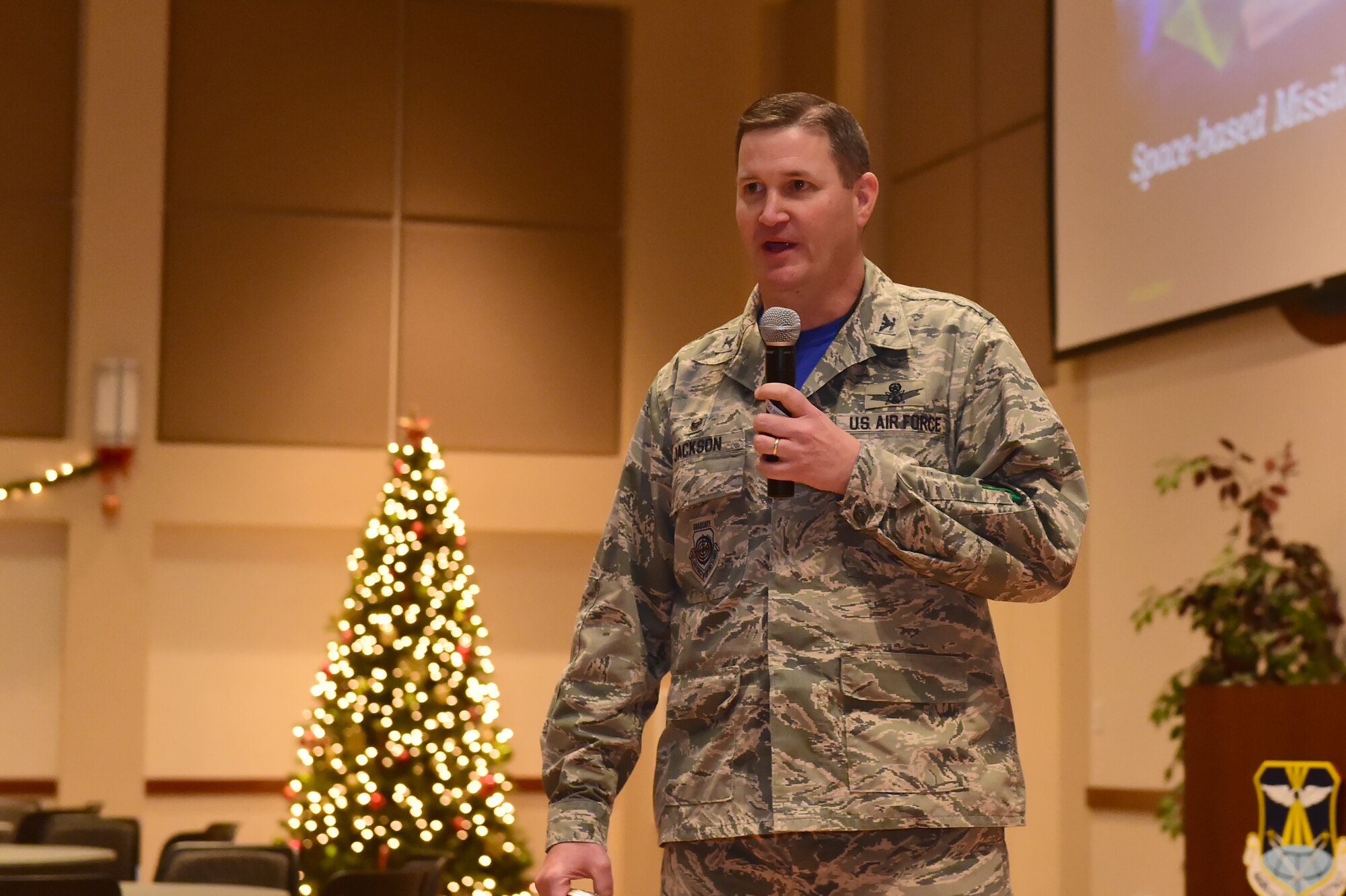 Col. Michael Jackson, 460th Space Wing Operations Group commander, speaks in front of an audience Dec. 4, 2015, at the Leadership Development Center on Buckley Air Force Base, Colo. Jackson spoke on the importance of the Defense Support Program in honor of Space-based Missile Warning Day, which was proclaimed by John W. Hickenlooper, Colorado governor. (U.S. Air Force photo by Airman 1st Class Luke W. Nowakowski/Released)