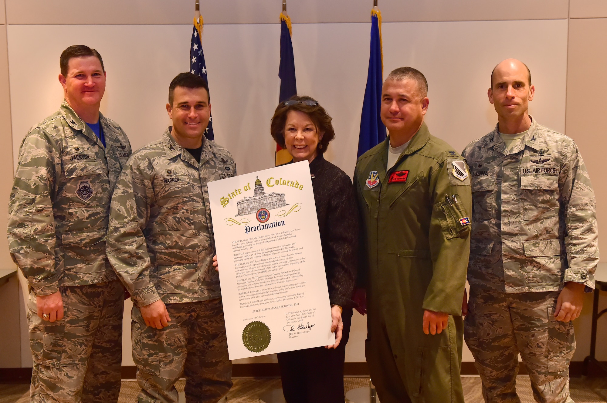 (From left) Col. Michael Jackson, 460th Space Wing Operations Group commander, Col. John Wagner, 460th Space Wing commander, Su Ryden, State Representative District 36, Col. Floyd Dunstan, 140th Wing commander and Col. Thomas Mckenna, 233rd Space Group commander, stand together with the proclamation stating Dec. 4 as Space-based Missile Warning Day Dec. 4, 2015, at the Leadership Development Center on Buckley Air Force Base, Colo. John W. Hickenlooper, Colorado governor, proclaimed that Dec. 4 will now and forever be Space-based Missile Warning Day in the State of Colorado. (U.S. Air Force photo by Airman 1st Class Luke W. Nowakowski/Released)