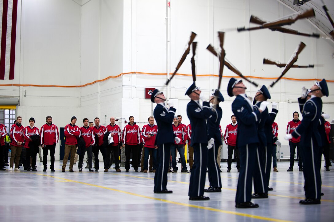 U.S. Air Force Honor Guard Drill Team members perform for Washington Capitals players during their visit to Joint Base Andrews, Md., Dec. 1, 2015. The Drill Team is the traveling component of the U.S. Air Force Honor Guard whose mission is to promote the Air Force by showcasing drill performances to recruit, retain, and inspire Airmen. (U.S. Air Force photo/Airman 1st Class Philip Bryant/released)
