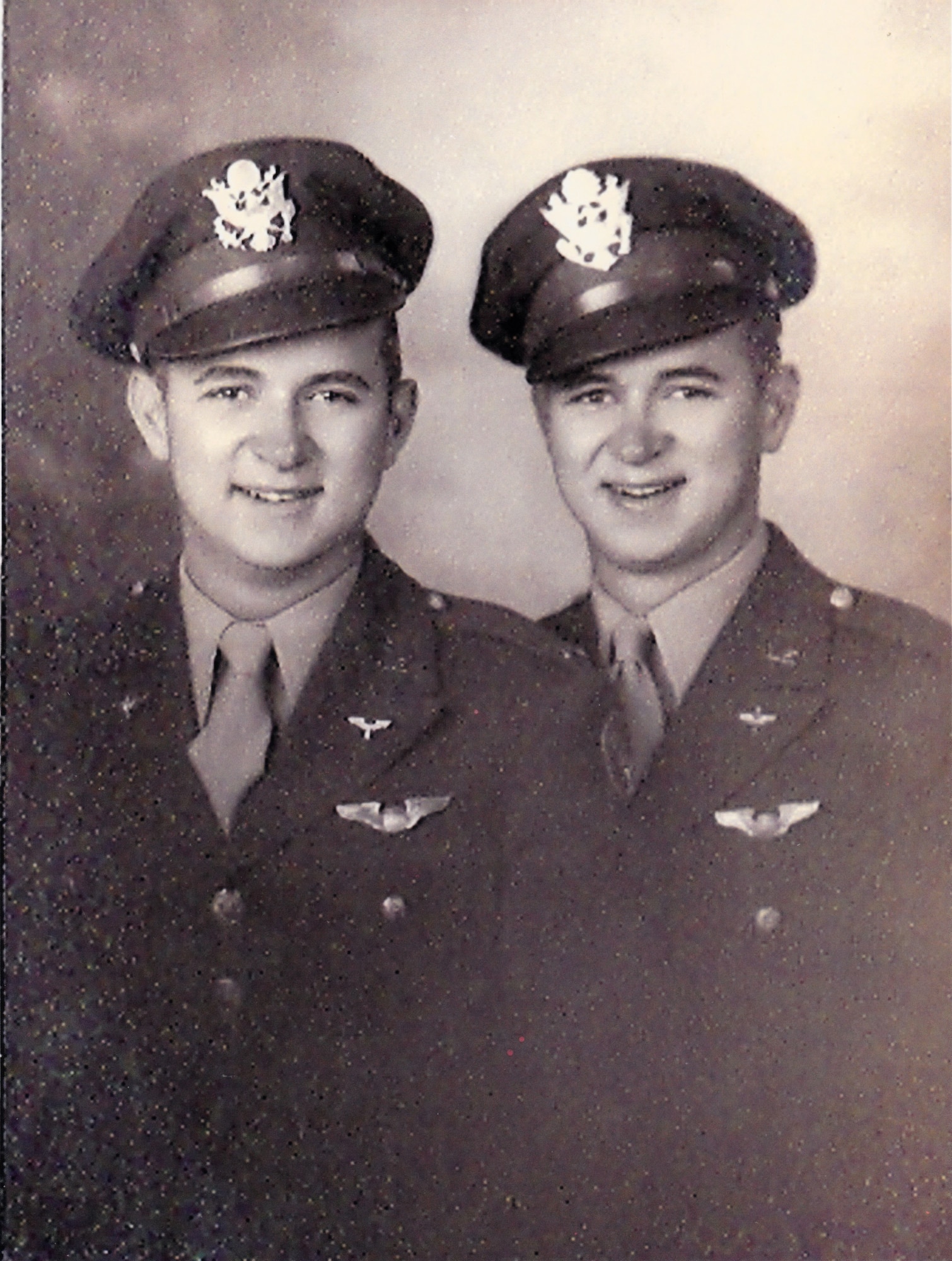 A vintage photo of retired Air Force Reserve Majs. Raymond “Glenn” Clanin and Russell “Lynn” Clanin as newly commissioned 2nd Lieutenants, receiving their pilot's wings in August 1944 at Ellington Field, Texas. Seventy-one years later, the 92-year-old twin brothers are recipients of the French government's highest distinction for their military service as World War II veterans, the Legion of Honor medal, presented by Christophe Lemoine, French consul general in Los Angeles, during a ceremony held at Los Angeles Air Force Base in El Segundo, Calif. (Courtesy photo, U.S. Army Air Forces, AAF Training Command, Ellington Field, Texas)