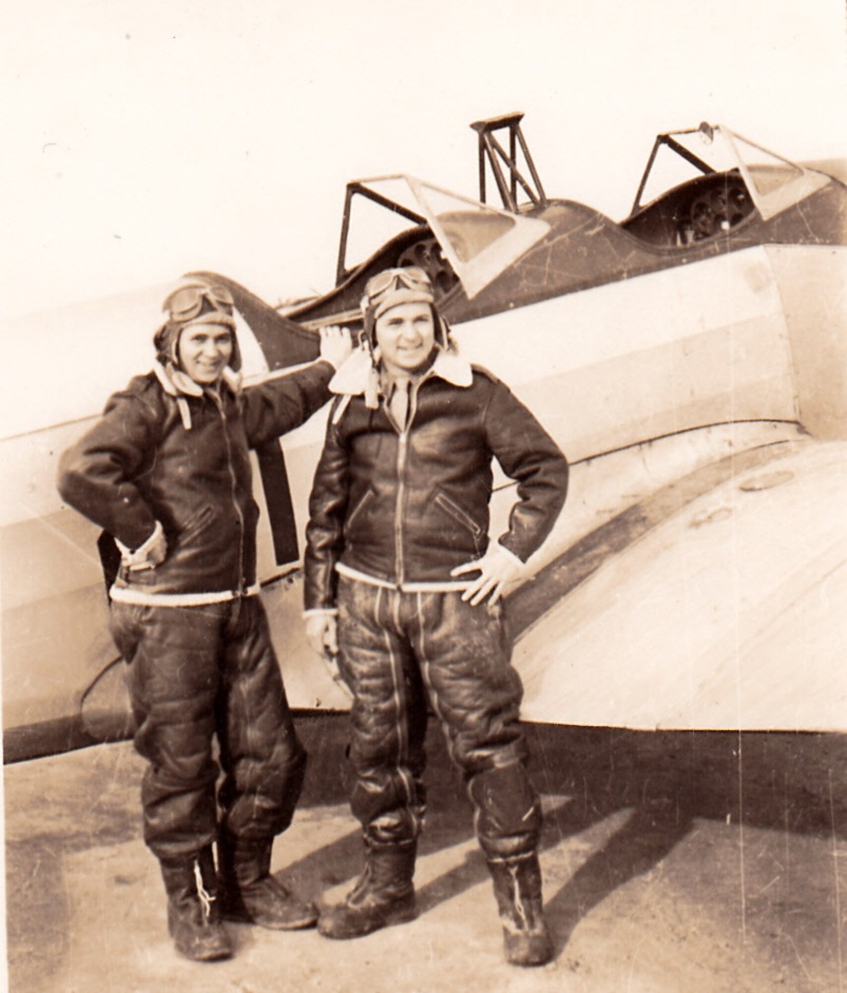 A vintage photo of retired Air Force Reserve Majs. Raymond “Glenn” Clanin and Russell “Lynn” Clanin in front of a PT-19 Trainer at the Aviation Cadet program at Michigan State College. They received their advanced training at various bases and were commissioned as 2nd Lieutenants, receiving their wings in August 1944 at Ellington Field, Texas. Seventy-one years later, the 92-year-old twin brothers are recipients of the French government's highest distinction for their military service as World War II veterans, the Legion of Honor medal, presented by Christophe Lemoine, French consul general in Los Angeles, during a ceremony held at Los Angeles Air Force Base in El Segundo, Calif. (Courtesy photo, U.S. Army Air Forces, AAF Training Command, Ellington Field, Texas)