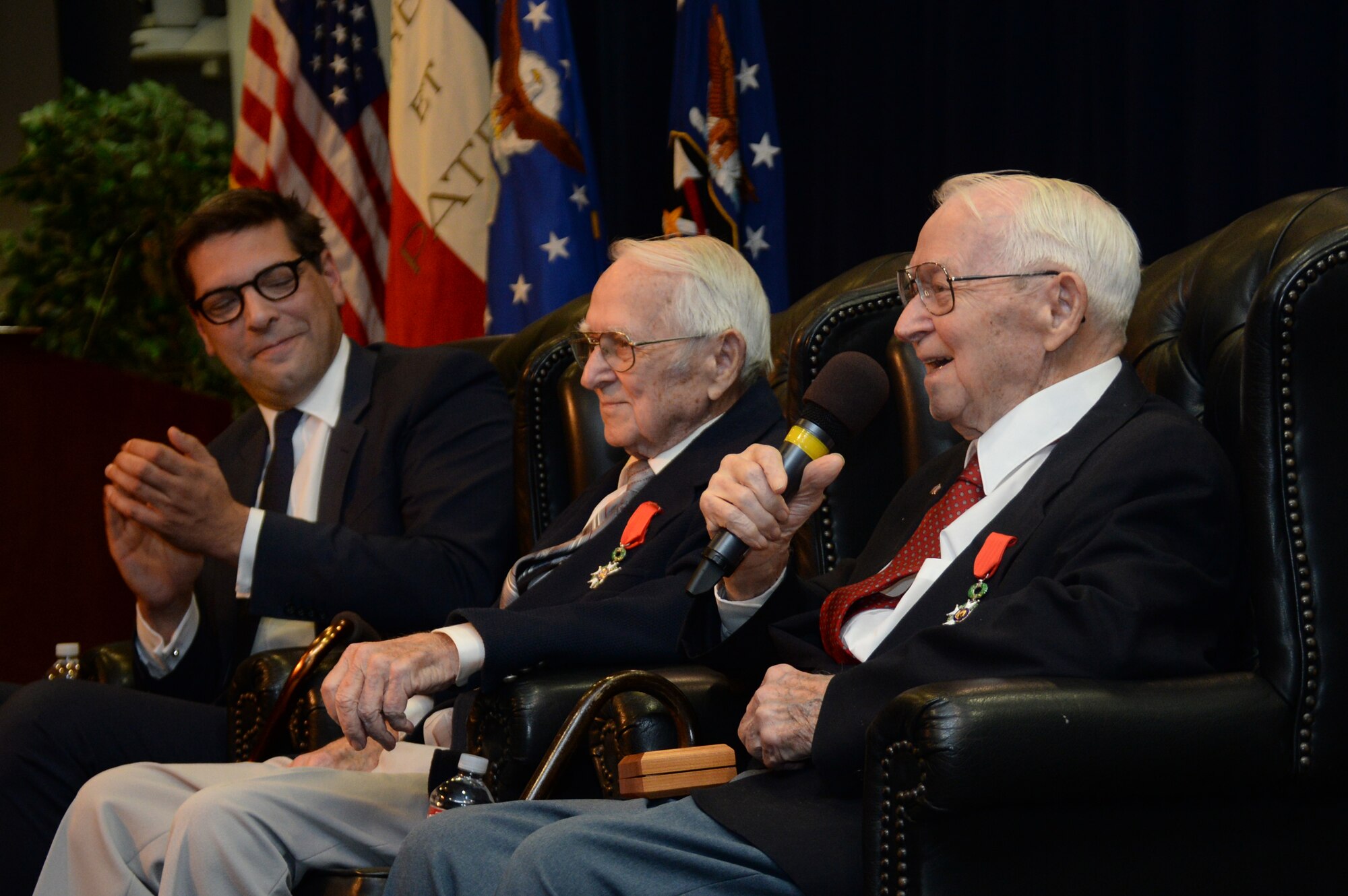 Retired Air Force Reserve Majs. and 92-year old twin brothers Raymond “Glenn” Clanin (with microphone) and Russell “Lynn” Clanin discuss some of their experiences as pilots of the B-26 Marauder named “Flak Bait” on several missions with the 449th Bombardment Squadron, 322nd Bomb Group, known as “The Annihilators,” while stationed in Beauvais, France. Glenn completed 26 missions while Lynn completed 21 missions in the twin-engine medium bomber. The brothers are recent recipients of the French government's highest distinction for their military service as World War II veterans, the Legion of Honor medal. (U.S. Air Force photo/Van De Ha)