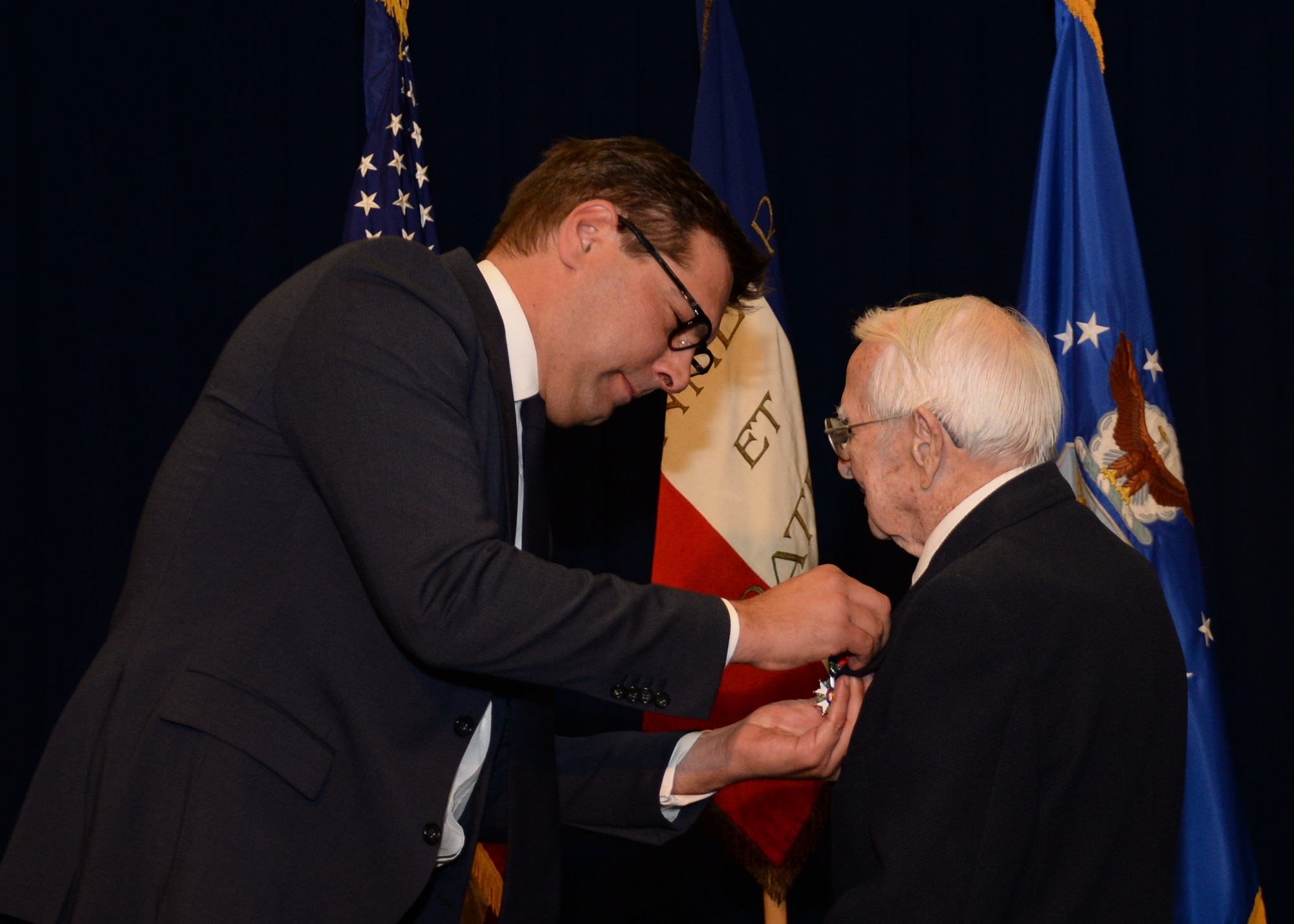 Christophe Lemoine, French consul general in Los Angeles, presents the Legion of Honor medal to retired Air Force Reserve Maj. Russell “Lynn” Clanin. The medal is the French government's highest distinction for military service as a World War II veteran. (U.S. Air Force photo/Van De Ha)