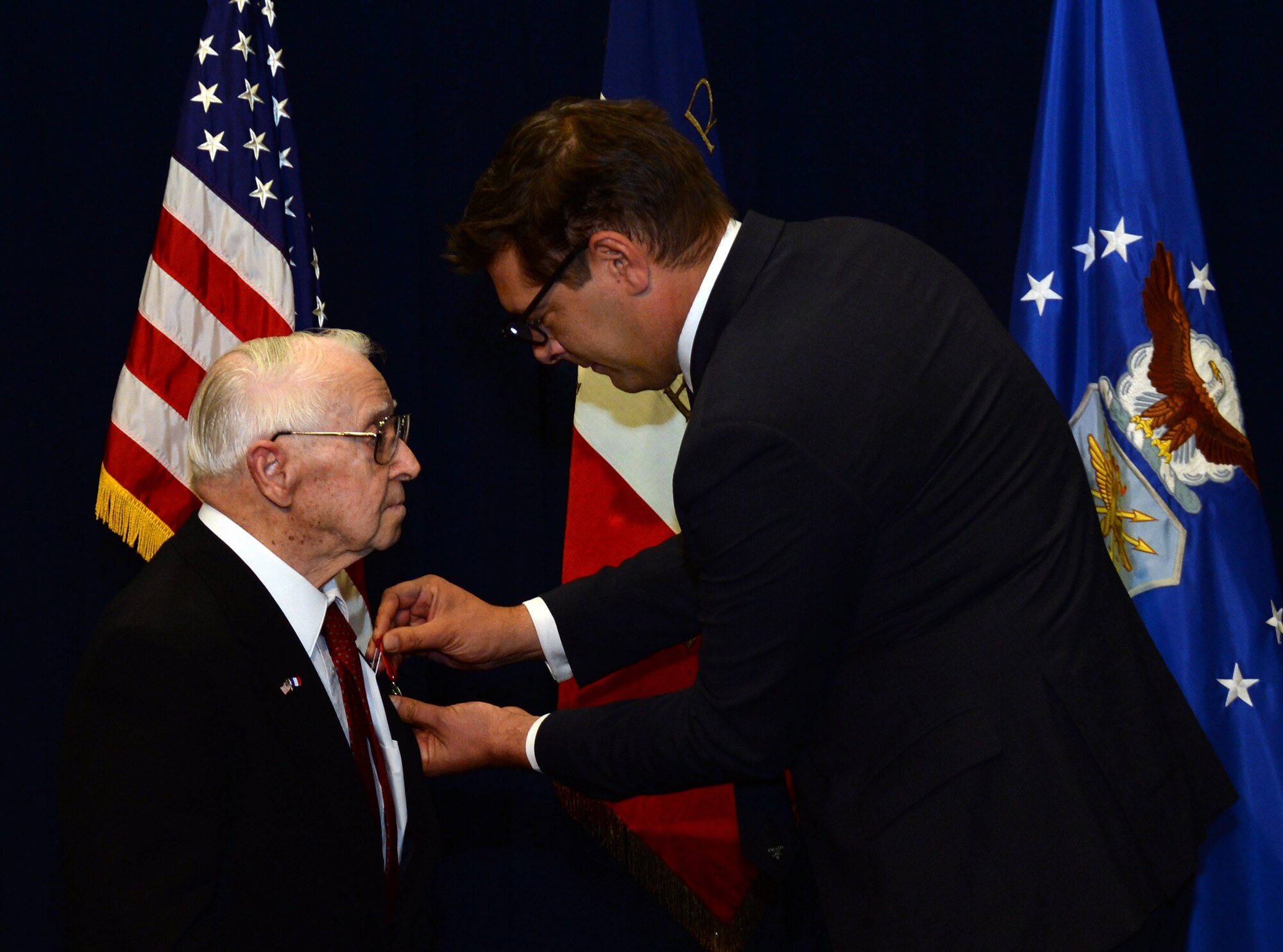 Christophe Lemoine, French consul general in Los Angeles, pins the Legion of Honor medal on retired Air Force Reserve Maj. Raymond “Glenn” Clanin. The medal is the French government's highest distinction for military service as a World War II veteran. (U.S. Air Force photo/Van De Ha)