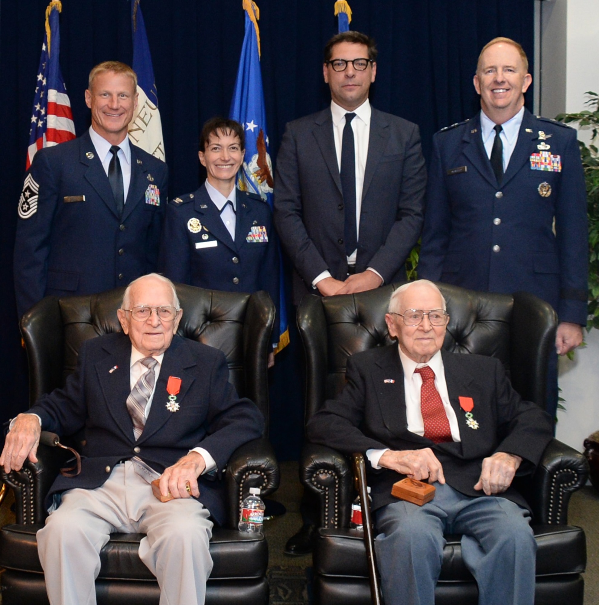 From left to right, Chief Master Sgt. Craig Hall, Space and Missile Systems Center command chief, Col. Donna Turner, 61st Air Base Group commander, Christophe Lemoine, French consul general in Los Angeles and Maj. Gen. Robert D. McMurry, Jr., SMC vice commander take a group photo with retired Air Force Reserve Majs. Russell “Lynn” Clanin and Raymond “Glenn” Clanin in the Gordon Conference Center at the Schriever Space Complex of the Space and Missile Systems Center at Los Angeles Air Force Base in El Segundo, Calif., Dec. 2. The 92-year-old twin brothers are the latest recipients of the French government's highest distinction for their military service as World War II veterans, the Legion of Honor medal. (U.S. Air Force photo/Van De Ha)