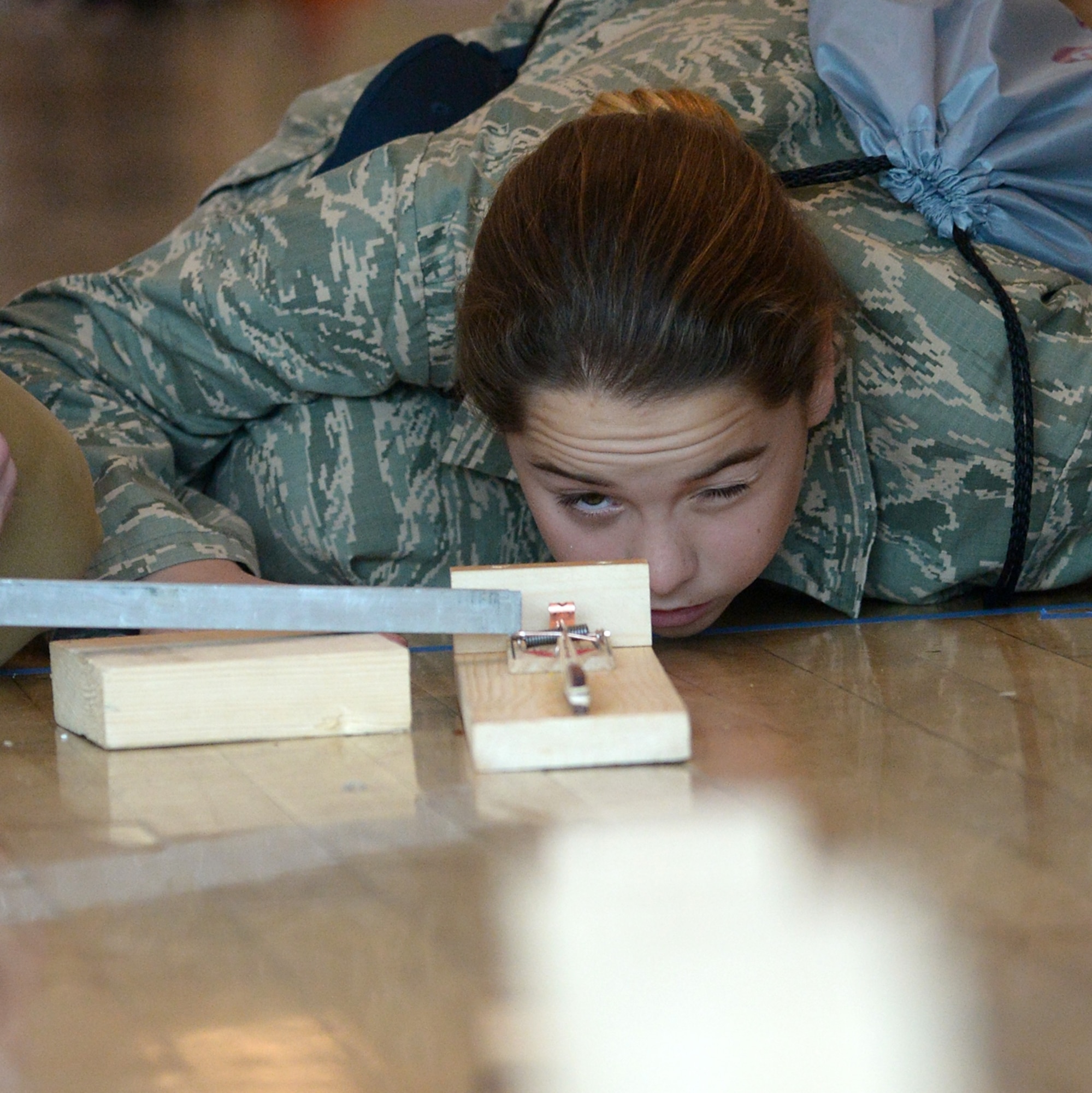 Cadet Airman Kaylie Parker from the Utah Military Academy tests her Rube Goldberg Machine before competition Dec. 4 at Weber State University, Ogden, Utah. Participants used science, technology, engineering and math knowledge and skills to design complex machines used to open an umbrella. (U.S. Air Force photo by Alex R. Lloyd)