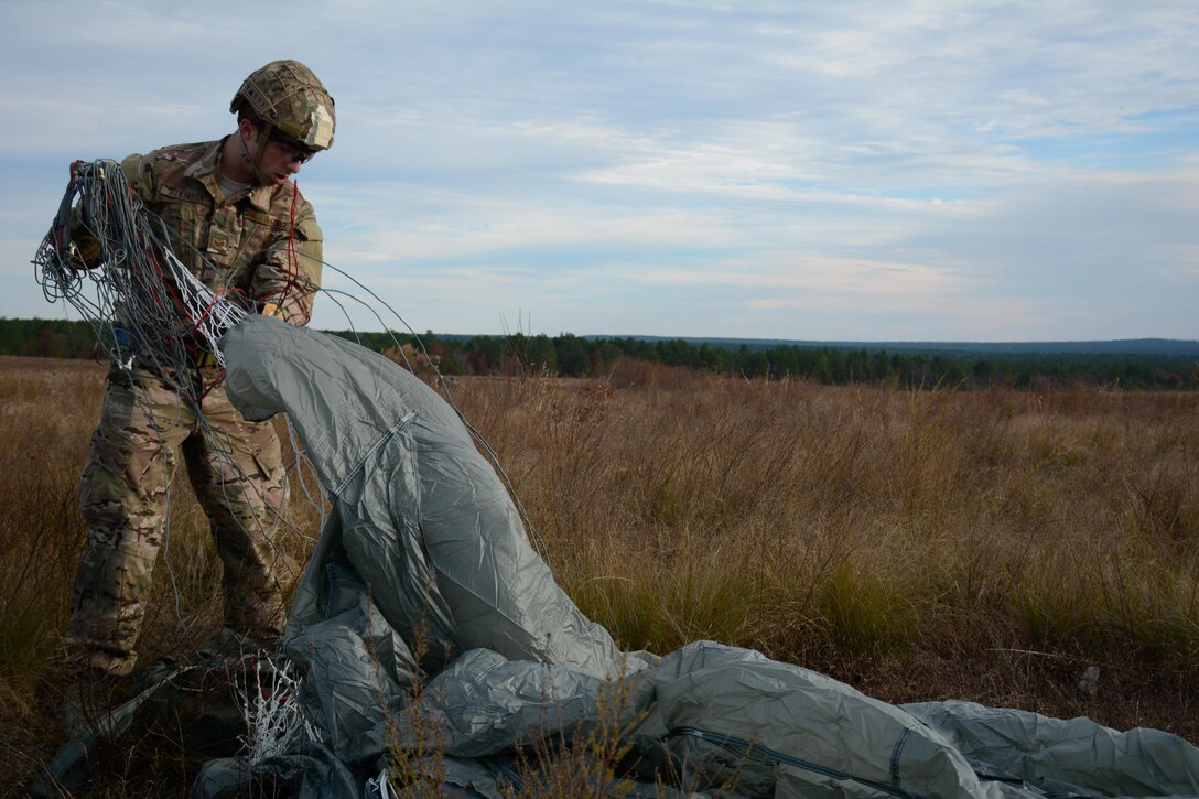 U.S. Airman Staff Sgt. Robert Atkinson of the 14th Air Support Operation Squadron puts his parachute into an aviator’s kit bag during Operation Toy Drop on Dec. 3, 2015 at Drop Zone Nijmegen on Fort Bragg, N.C. Operation Toy Drop is the world’s largest combined airborne operation with seven partner-nation paratroopers participating and allows Soldiers the opportunity to help children in need everywhere receive toys for the holidays. (U.S. Army photo by Pfc. Darion Gibson)