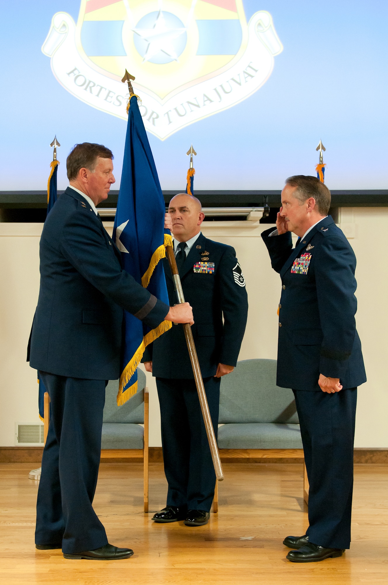 Brig. Gen. Gregory L. Nelson passes his general officer flag to Kentucky's adjutant general, Maj. Gen. Edward W. Tonini, during Nelson's retirement ceremony at the Kentucky Air National Guard Base in Louisville, Ky., Nov. 8, 2015. Nelson, who most recently served as vice director for strategy, policy, plans and international affairs at the National Guard Bureau, completed more than 40 years of faithful service to U.S. Air Force and Kentucky Air National Guard. (U.S. Air National Guard photo by Tech. Sgt. Vicky Spesard)