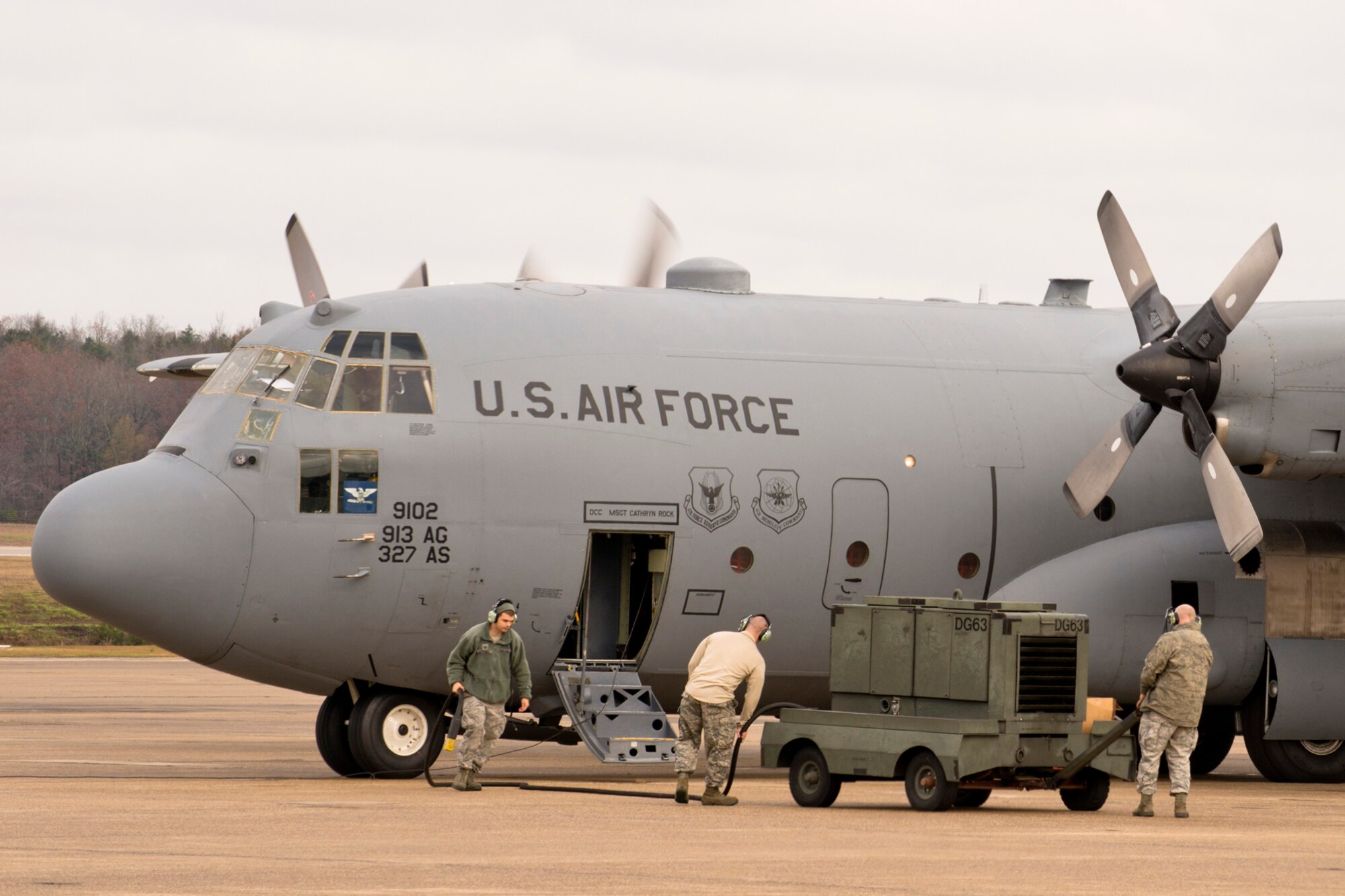 (From Left) U.S. Air Force Tech Sgts. Timothy Hammonds, David Chismark and Master Sgt. Steven Lessard, remove an external power cart from a C-130H Hercules at Little Rock Air Force Base, Ark., Dec. 1, 2015. All three Airmen are crew chiefs assigned to the 913th Maintenance Squadron, and always ensure their planes are ready for world-wide missions. (U.S. Air Force photo by Master Sgt. Jeff Walston/Released) 