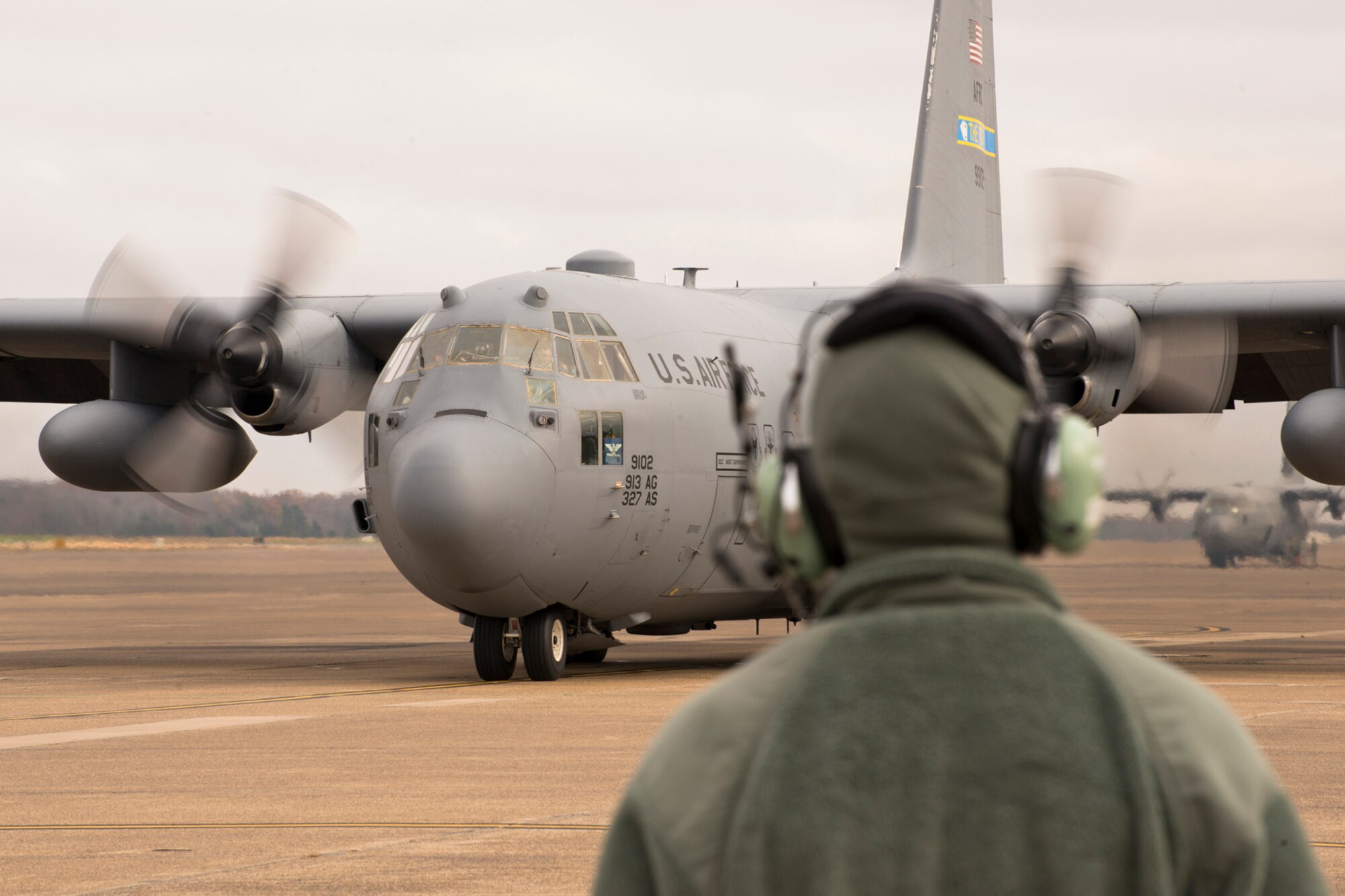 U.S. Air Force Tech Sgt. Timothy Hammonds, a crew chief assigned to the 913th Maintenance Squadron, waits to marshal a C-130H Hercules at Little Rock Air Force Base, Ark., Dec. 1, 2015. As a crew chief, Hammonds’ responsibilities include certifying the 913th Airlift Group’s aircraft are ready to complete Air Force missions. (U.S. Air Force photo by Master Sgt. Jeff Walston/Released) 