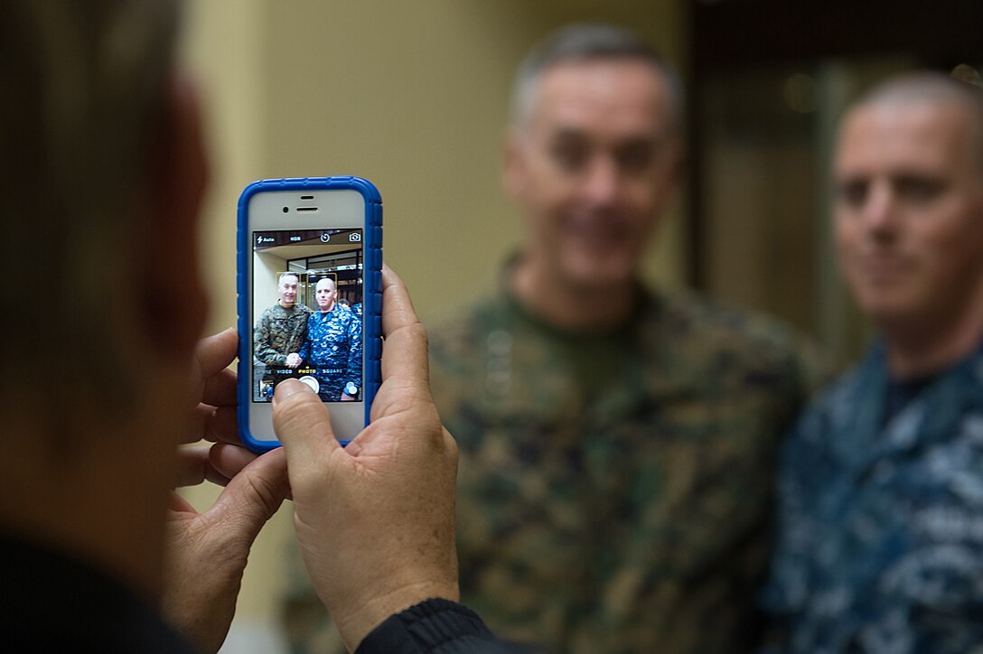 U.S. Marine Corps Gen. Joseph F. Dunford Jr., chairman of the Joint Chiefs of Staff, poses for a photo with a U.S. sailor on Naval Air Station Sigonella, Italy, Dec. 5, 2015. DoD photo by D. Myles Cullen