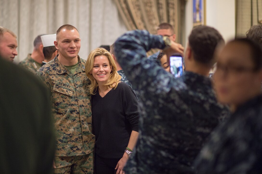 Actress Elizabeth Banks takes photos with U.S. service members during a USO visit on Naval Air Station Sigonella, Italy, Dec. 5, 2015. DoD photo by D. Myles Cullen