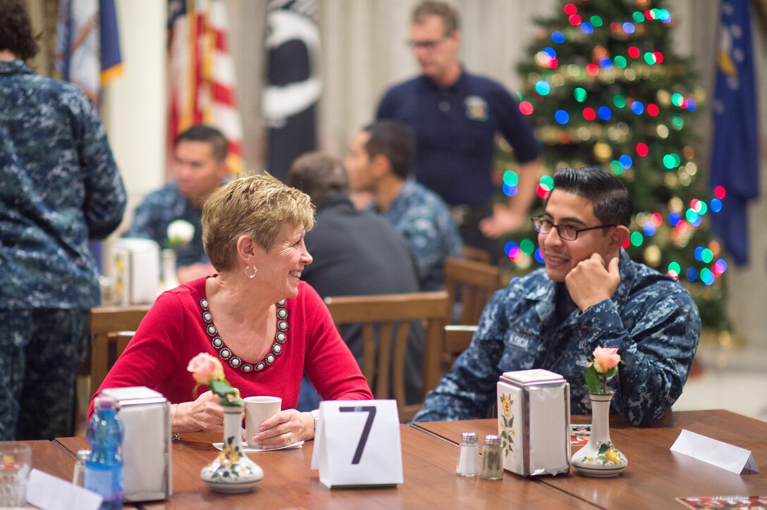 Ellyn Dunford, wife of U.S. Marine Corps Gen. Joseph F. Dunford Jr., talks with a U.S. sailor on Naval Air Station Sigonella, Italy, Dec. 5, 2015. DoD photo by D. Myles Cullen