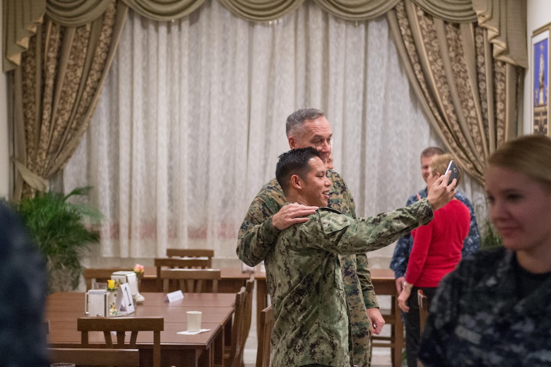 U.S. Marine Corps Gen. Joseph F. Dunford Jr., chairman of the Joint Chiefs of Staff, stands for a photo with a U.S. service member on Naval Air Station Sigonella, Italy, Dec. 5, 2015. DoD photo by D. Myles Cullen