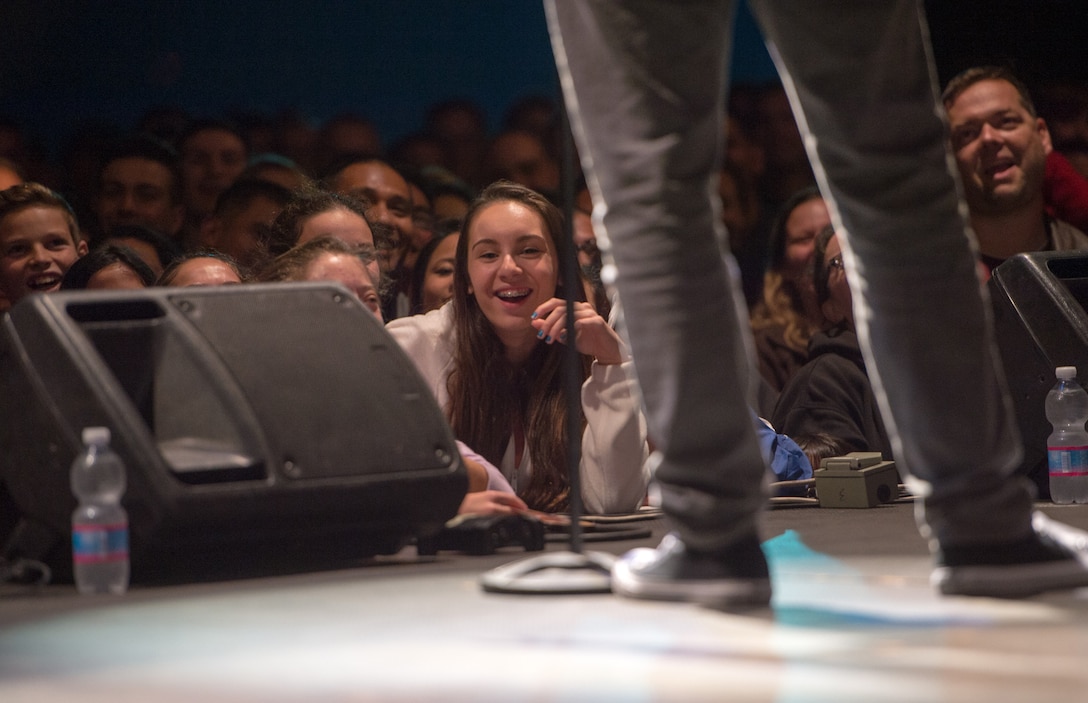 Audience members react as comedian Sydney Castillo performs during a USO show on Naval Air Station Sigonella, Italy, Dec. 5, 2015. DoD photo by D. Myles Cullen
