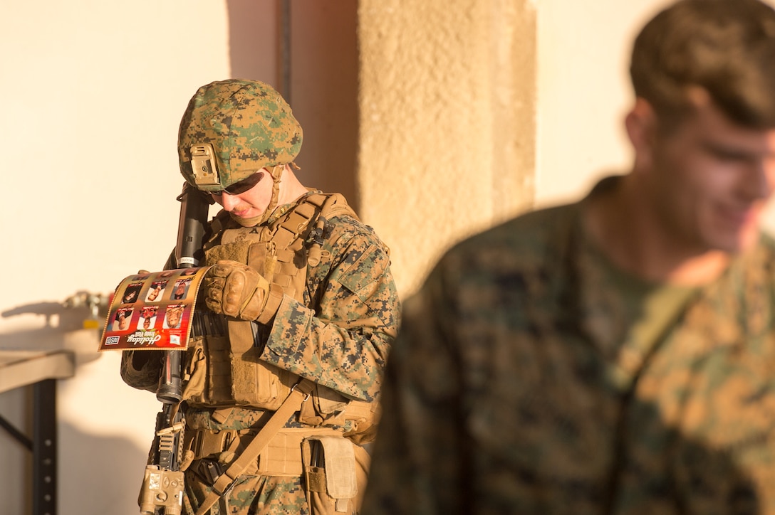 A U.S. Marine looks over a USO flier on Naval Air Station Sigonella, Italy, Dec. 5, 2015. DoD photo by D. Myles Cullen